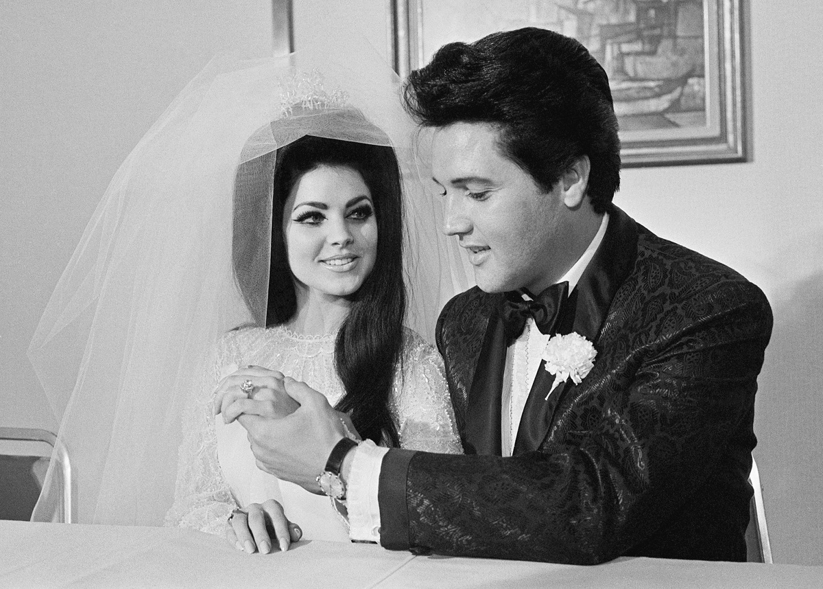 Elvis Presley shows off his wife Priscilla's three-carat diamond wedding ring on their wedding day in Las Vegas