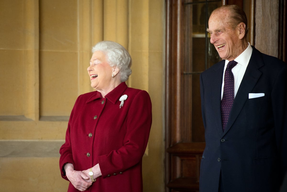 Queen Elizabeth and Prince Philip laughing together as they say goodbye to the Irish president
