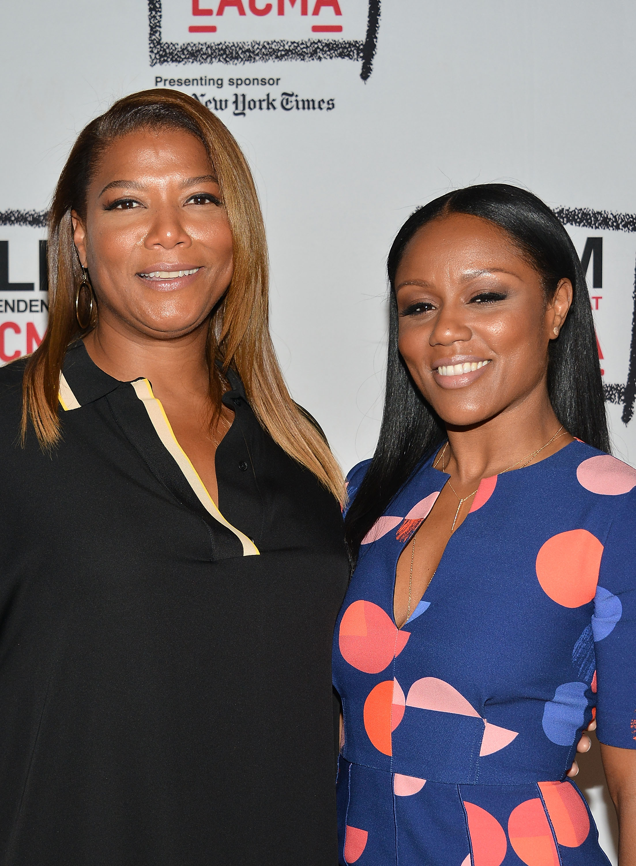 Queen Latifah and Eboni Nichols smiling at an event.