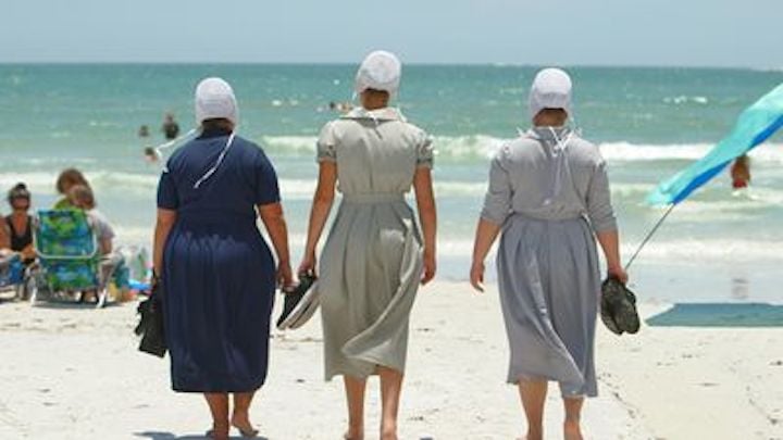 Three women from 'Breaking Amish' walking on a beach with their backs turned for 'Return to Amish'