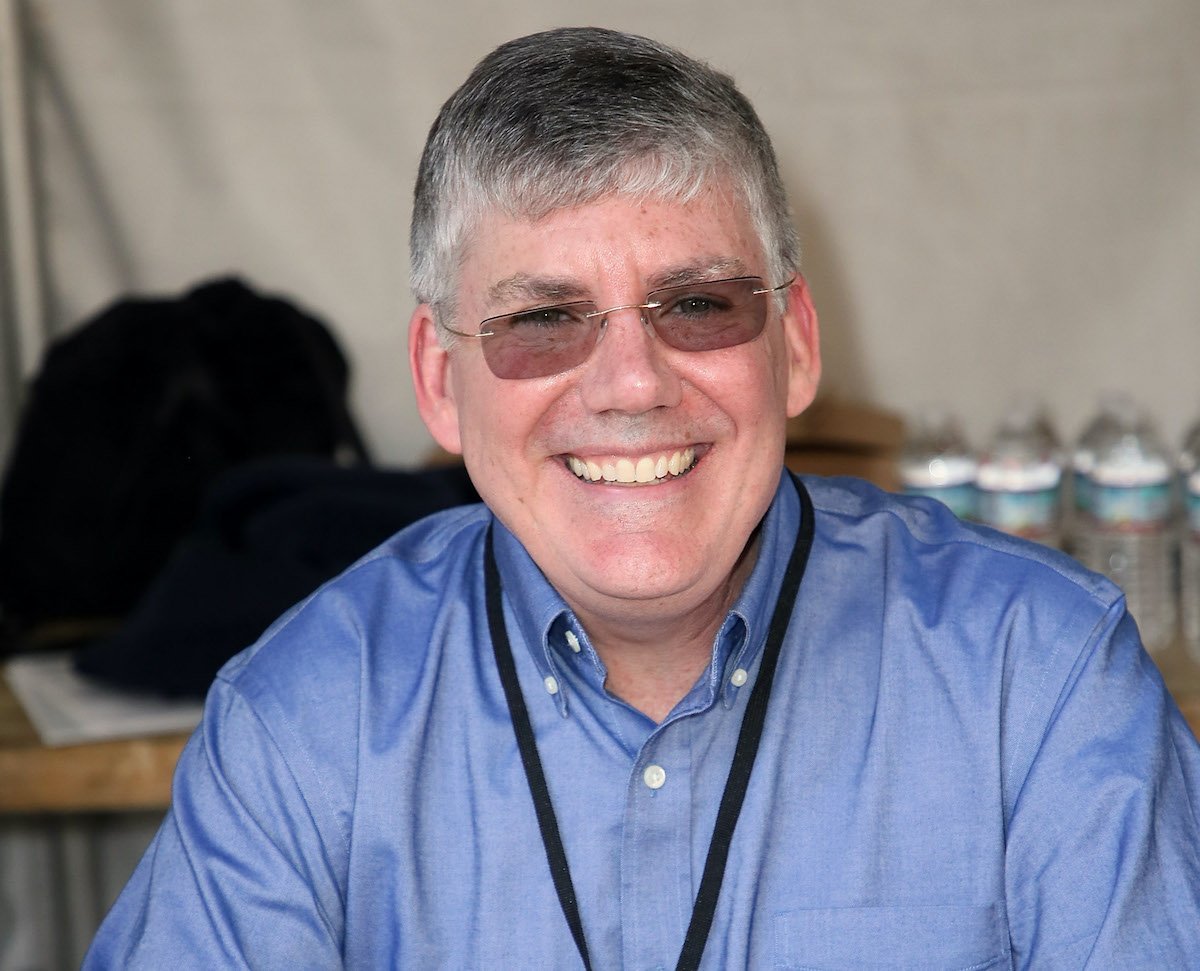 Author Rick Riordan smiles while sitting at a table at the 23rd LA Times Festival of Books at USC on April 21, 2018