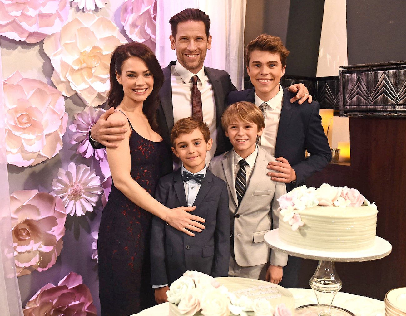 Rebecca Herbst, Roger Howarth, and their on-screen kids in a still from General Hospital