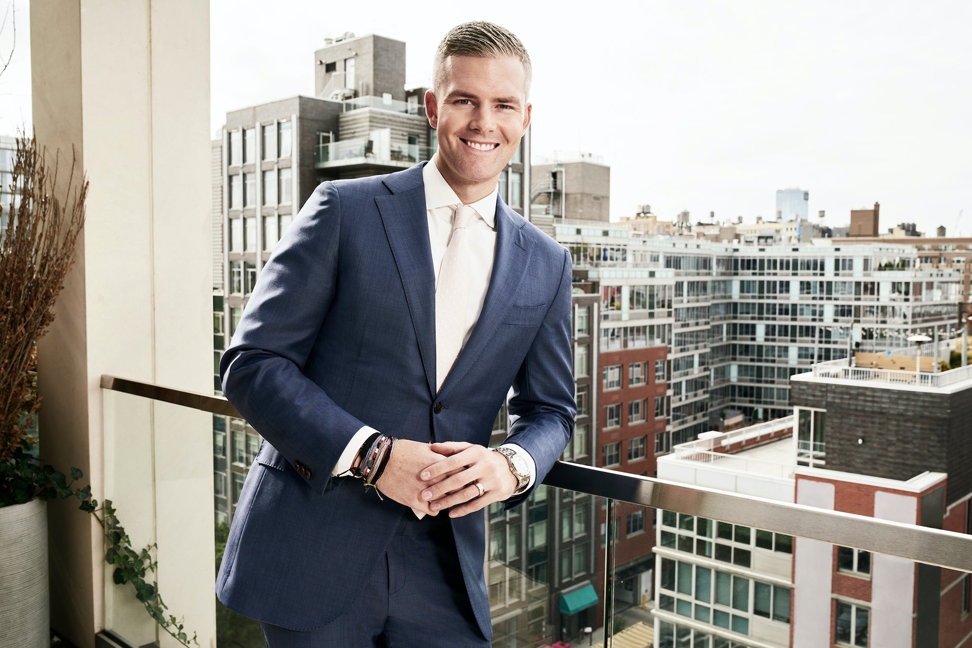 Ryan Serhant smiling in front of a cityscape