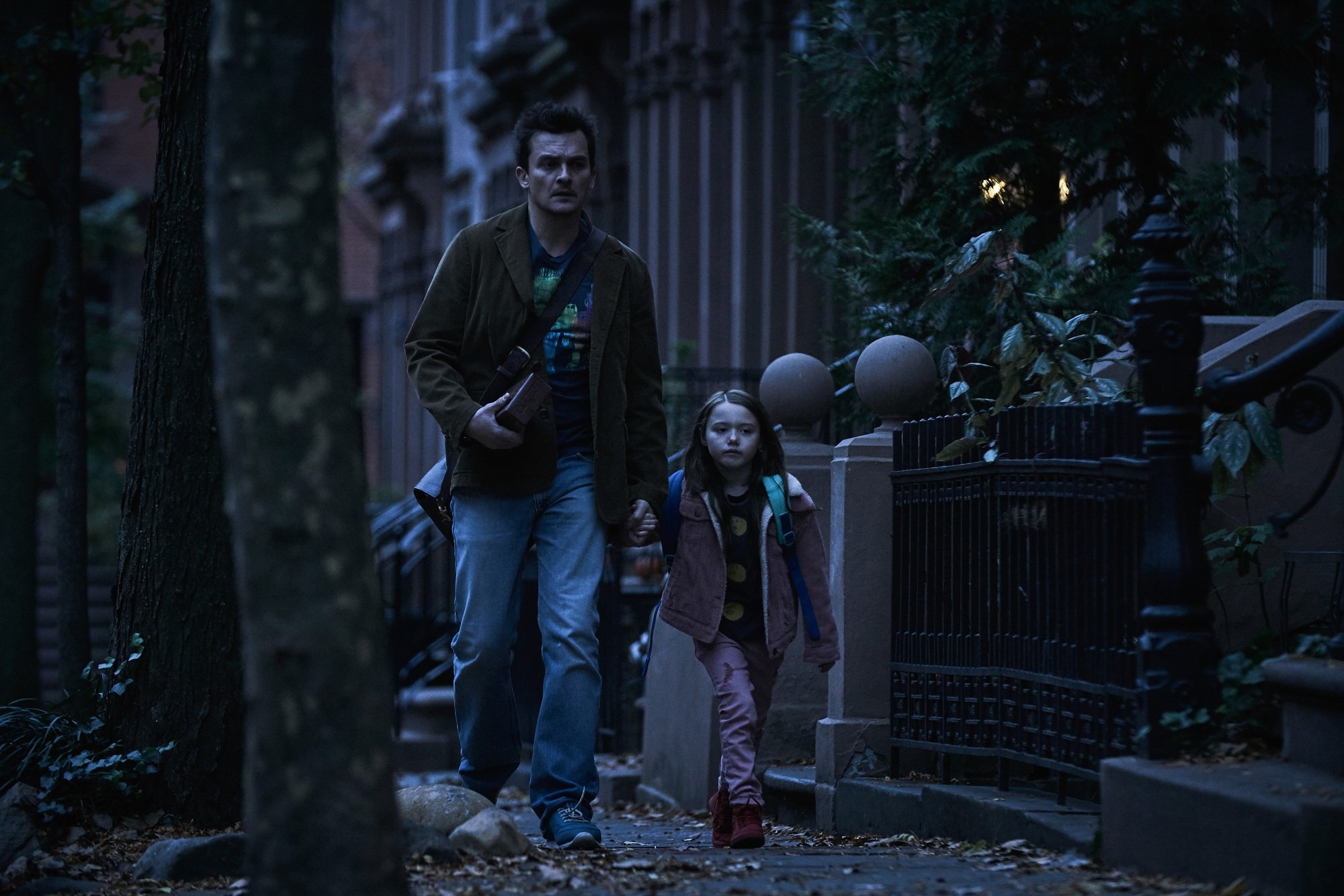 Separation star Rupert Friend walks down the street with Violet McGraw
