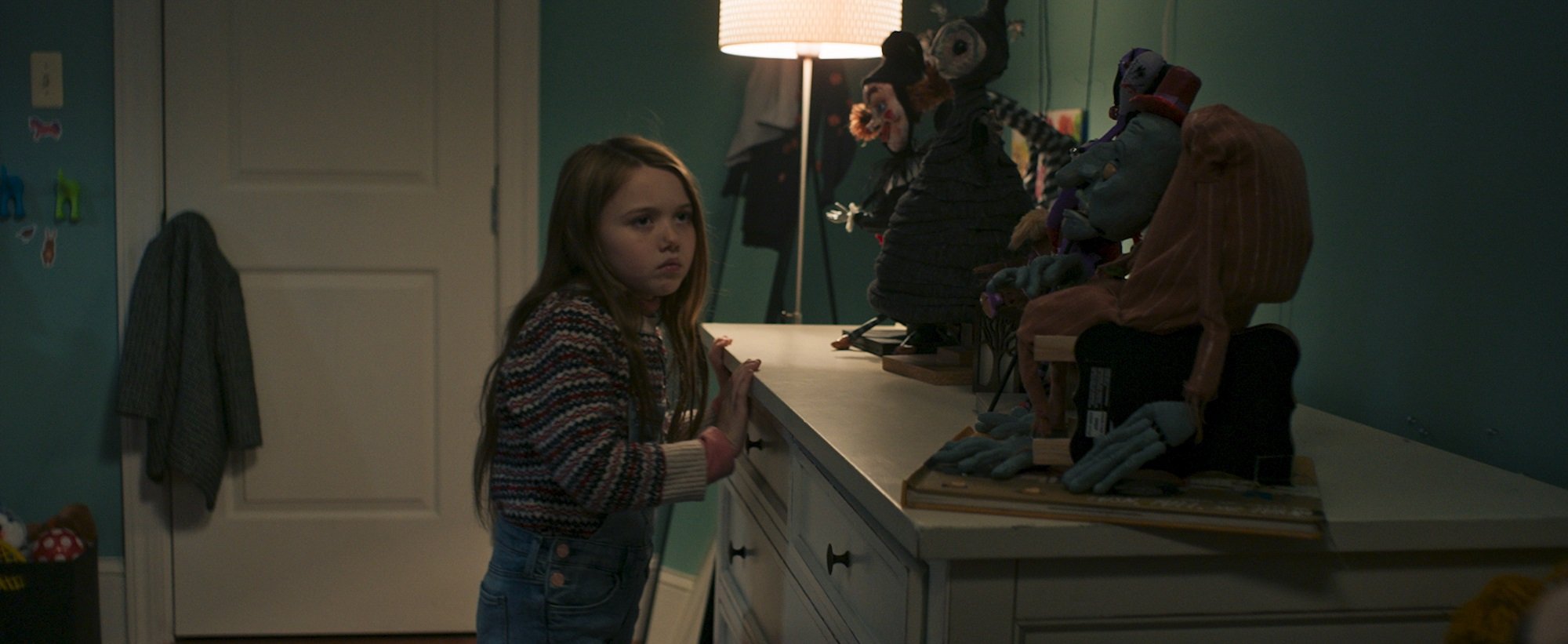 Separation star Violet McGraw looks at puppets