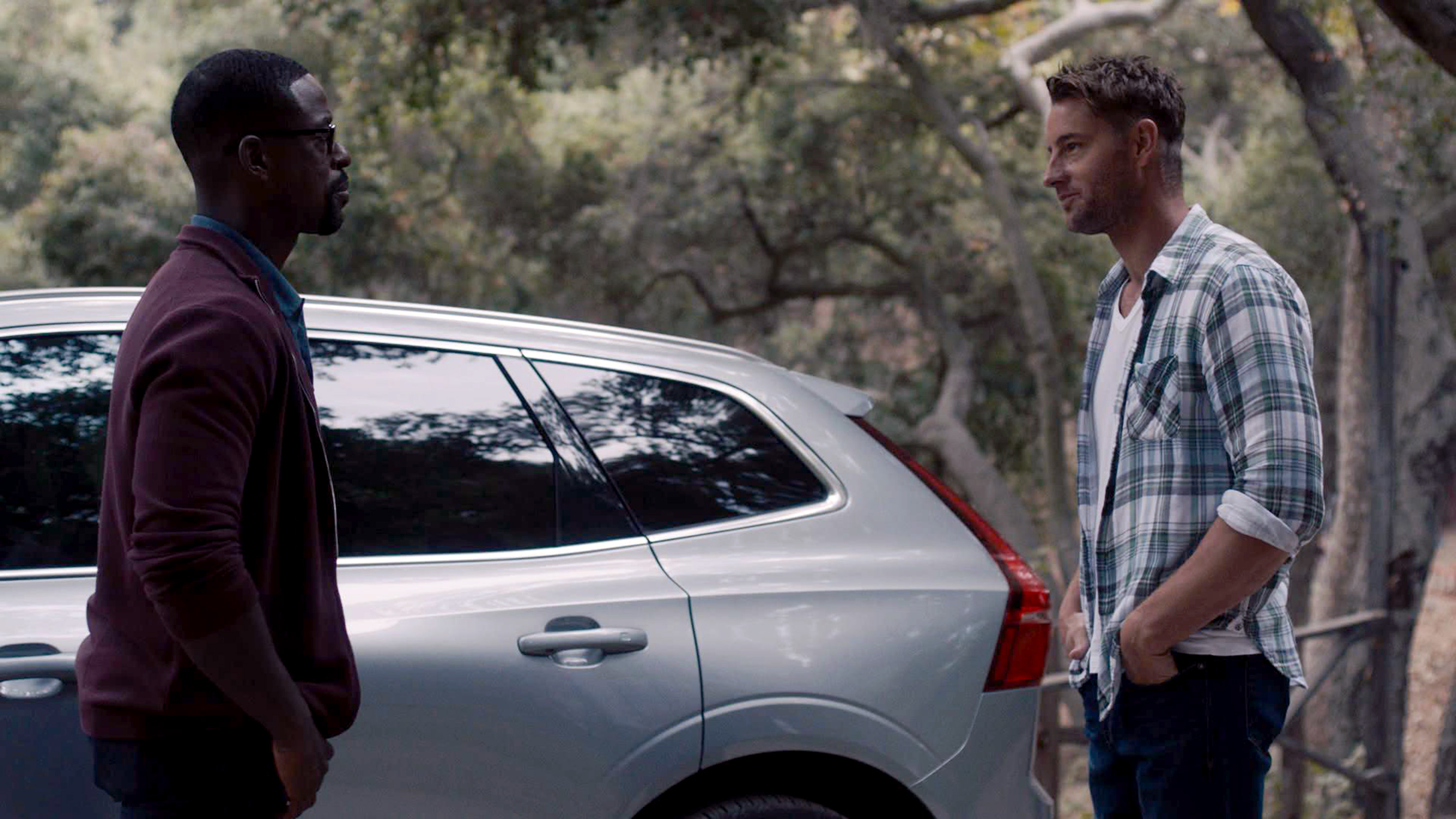 Sterling K. Brown and Justin Hartley stand by Randall's car
