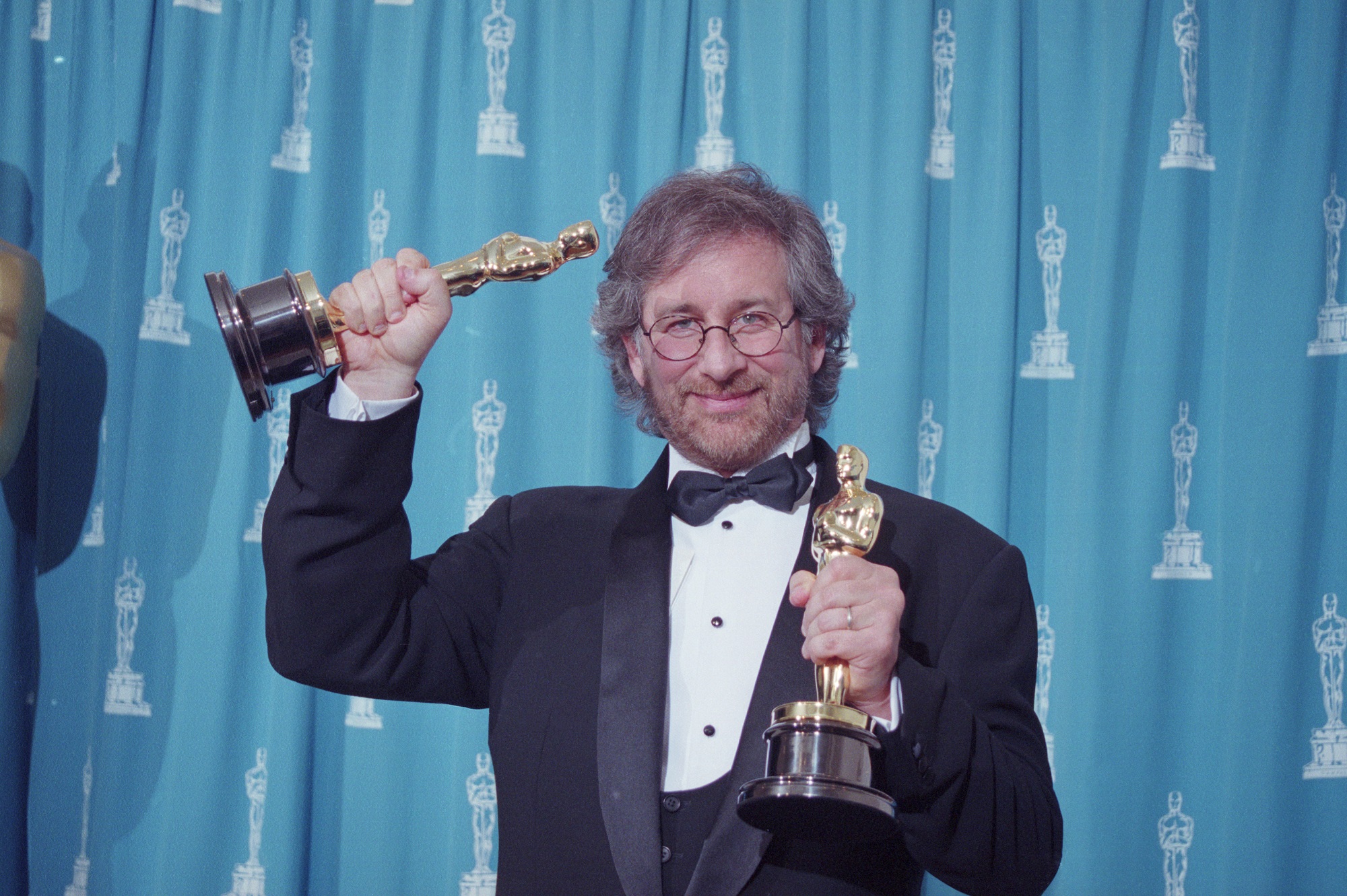 Steven Spielberg holding 2 Oscars