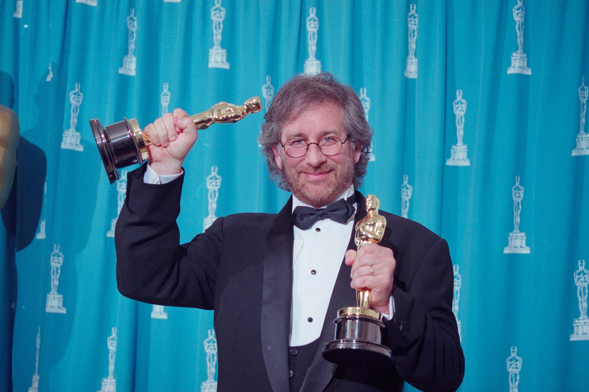 Steven Spielberg holding 2 Oscars