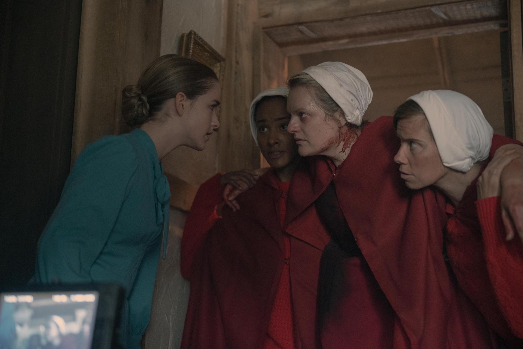 Three of the handmaids talking to Esther in The Handmaid's Tale Season 4