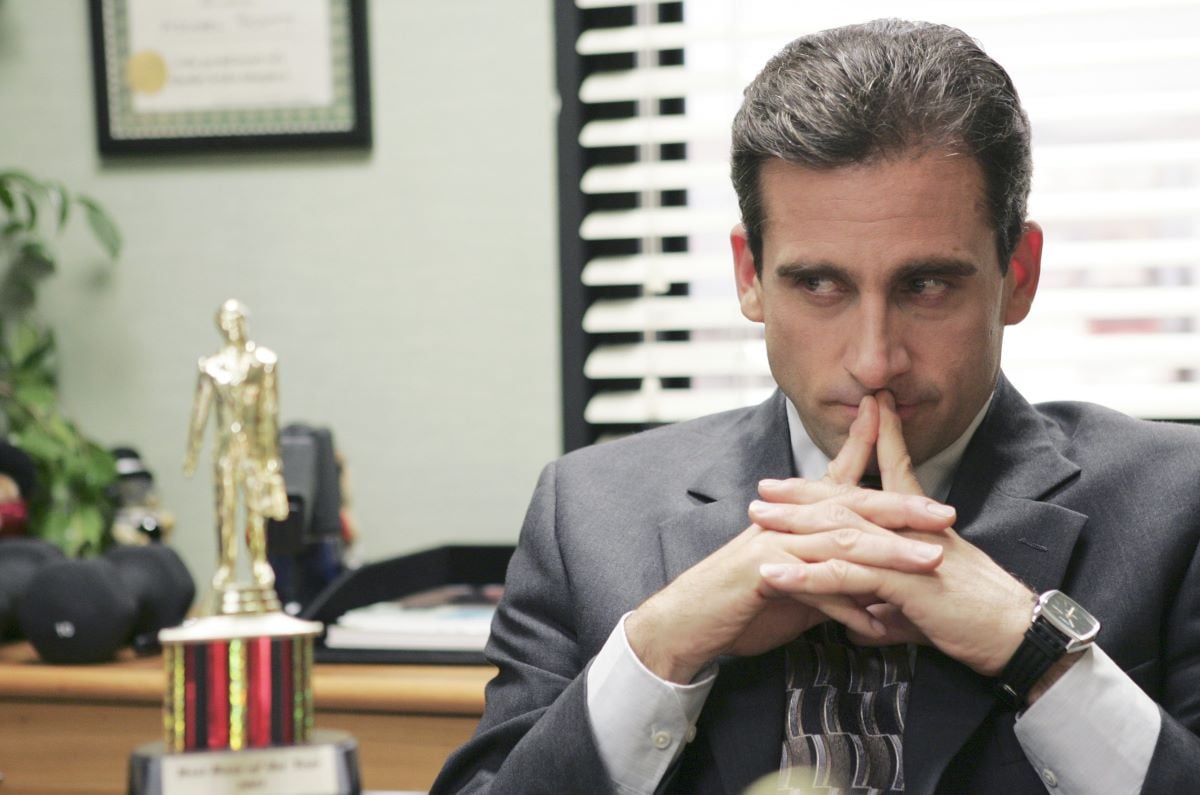 Steve Carell as Michael Scott sits in his office looking at a trophyon 'The Office'