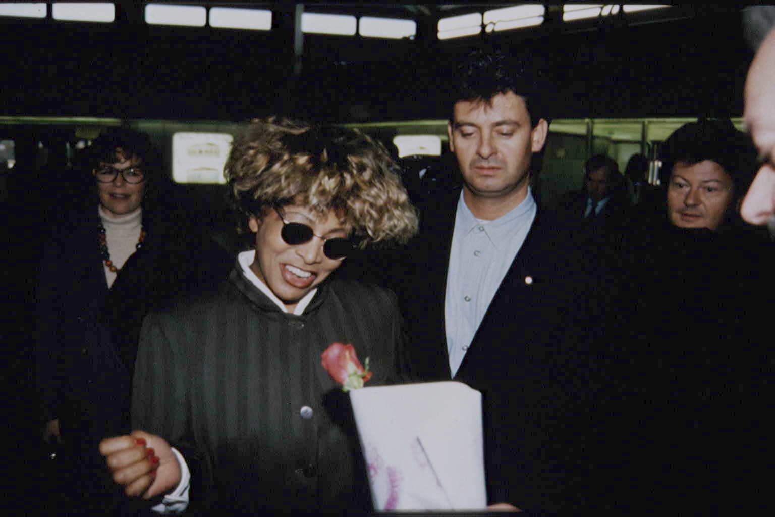 Tina Turner wearing sunglasses walking with Erwin Bach