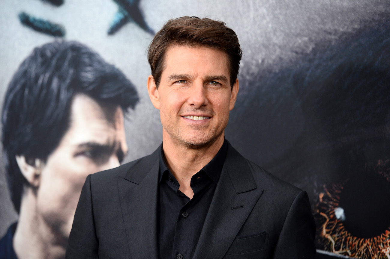 Tom Cruise looks on