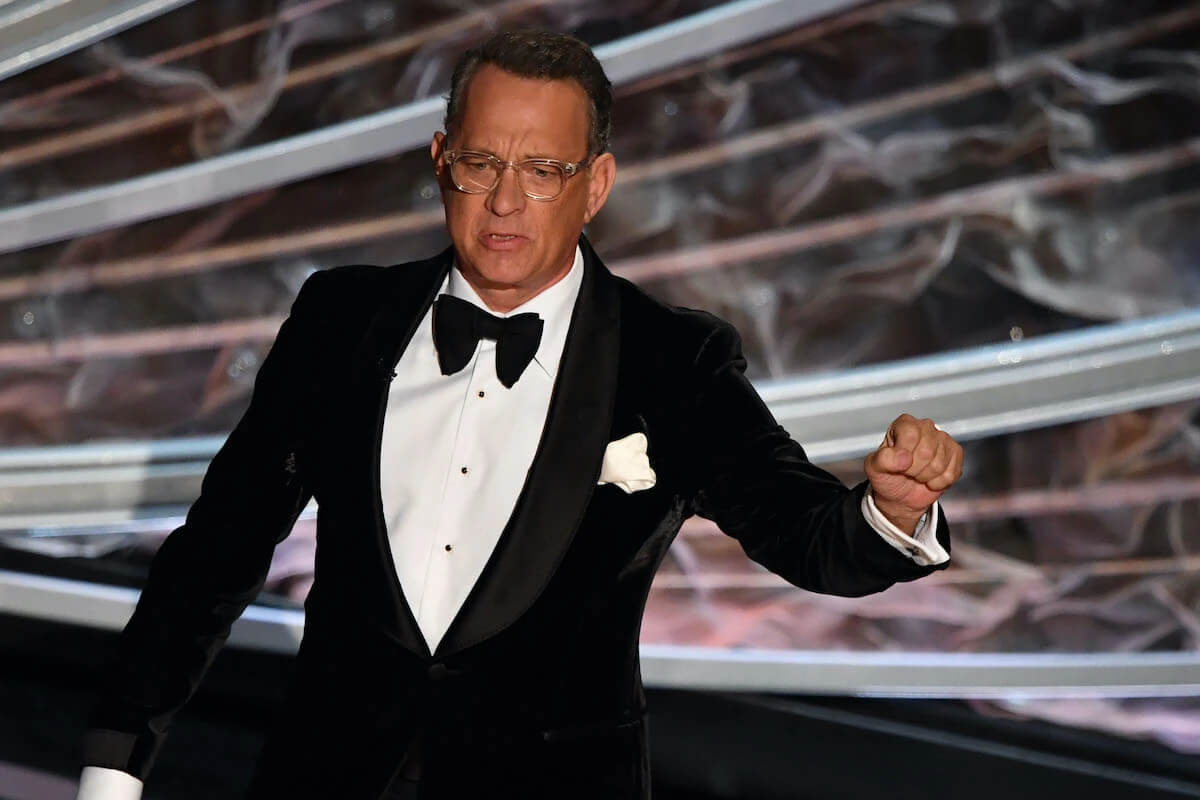 Tom Hanks at the 92nd Oscars in 2020 wearing a tuxedo and glasses.