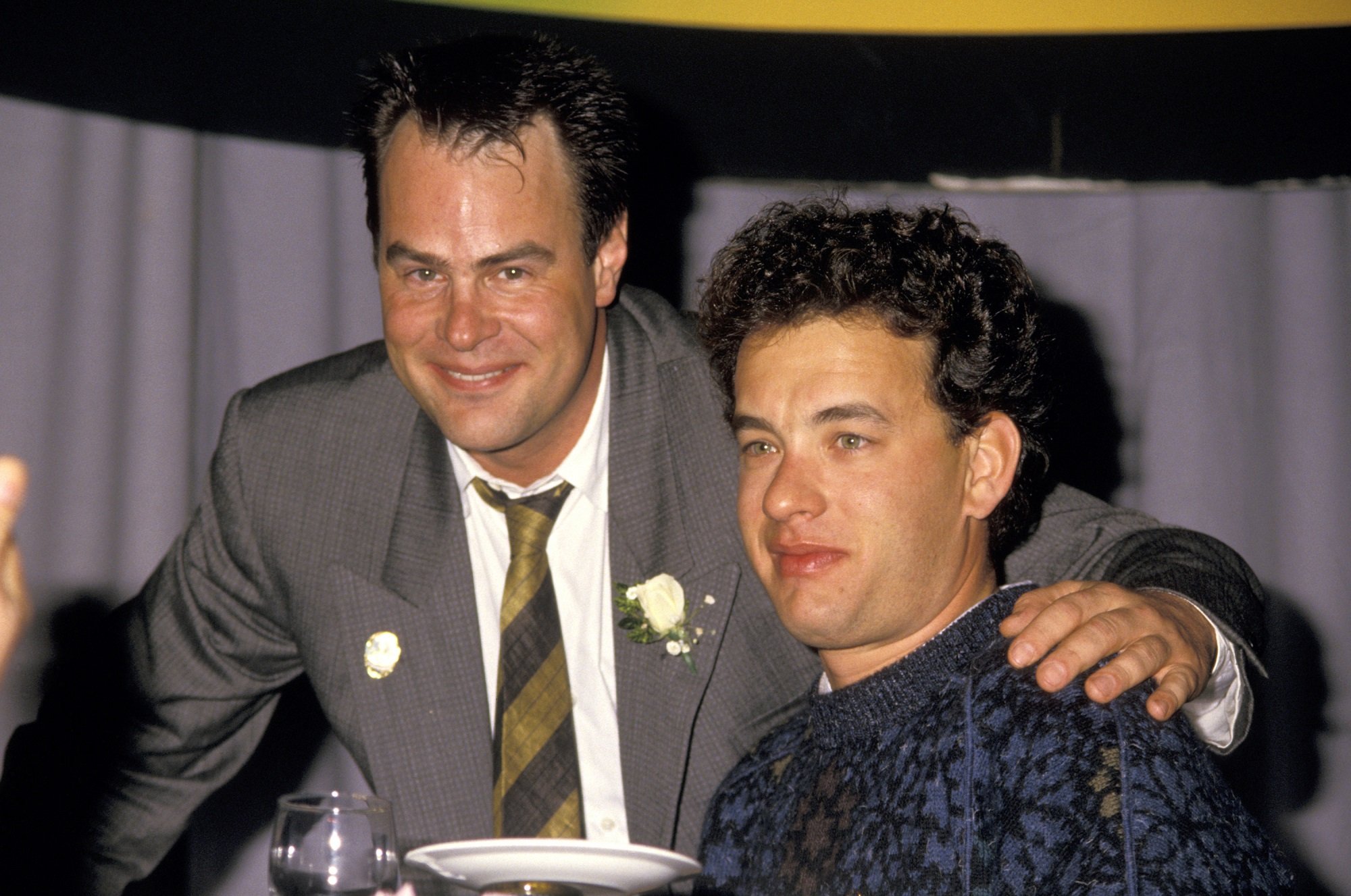 Dan Aykroyd puts his arm around Tom Hanks