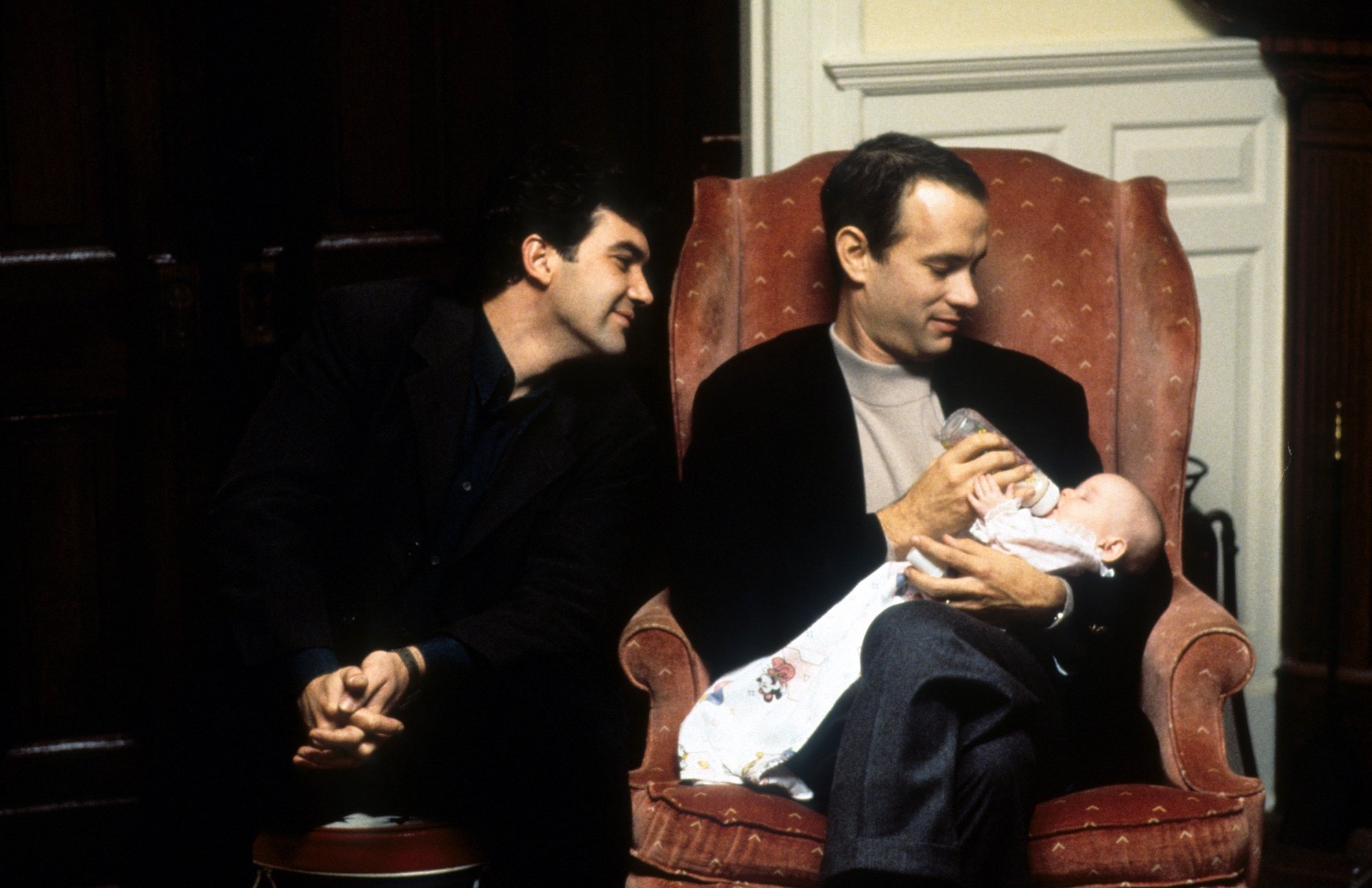 Tom Hanks holds a baby with Antonio Banderas in Philadelphia