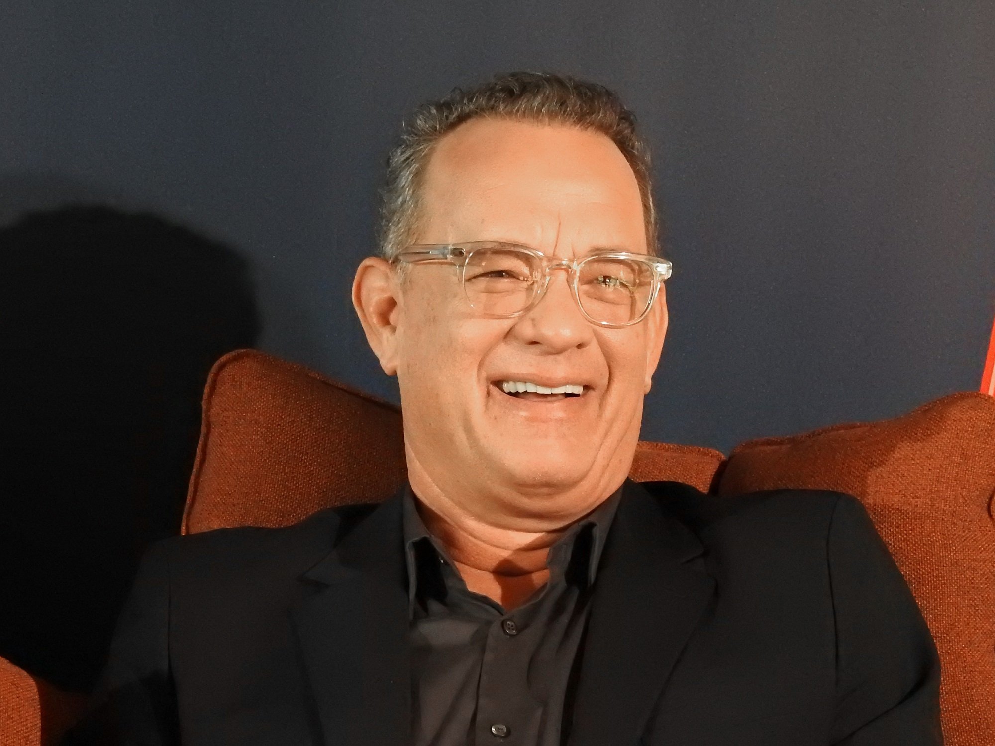 Tom Hanks sitting in an orange chair