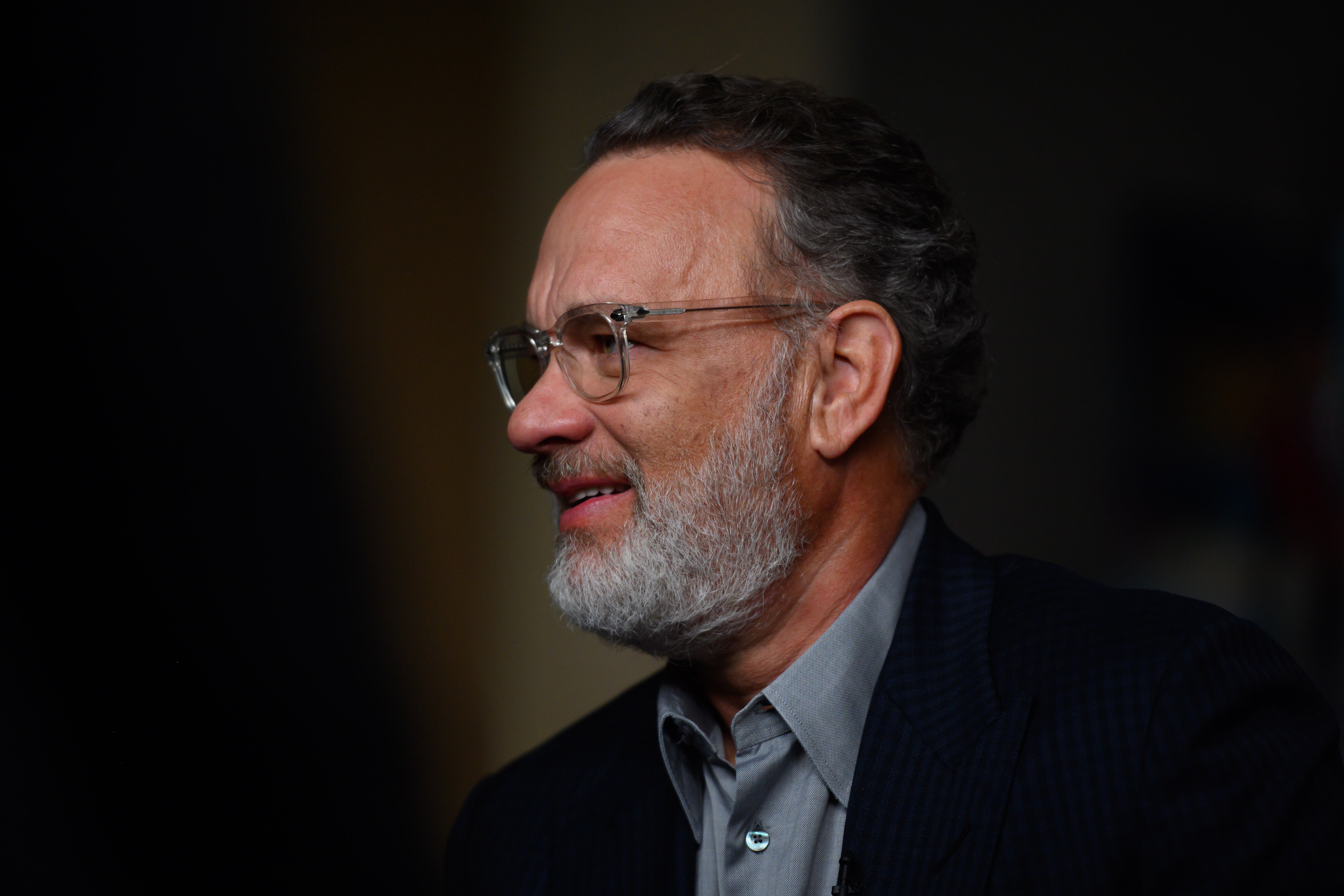 Tom Hanks with a beard wearing glasses