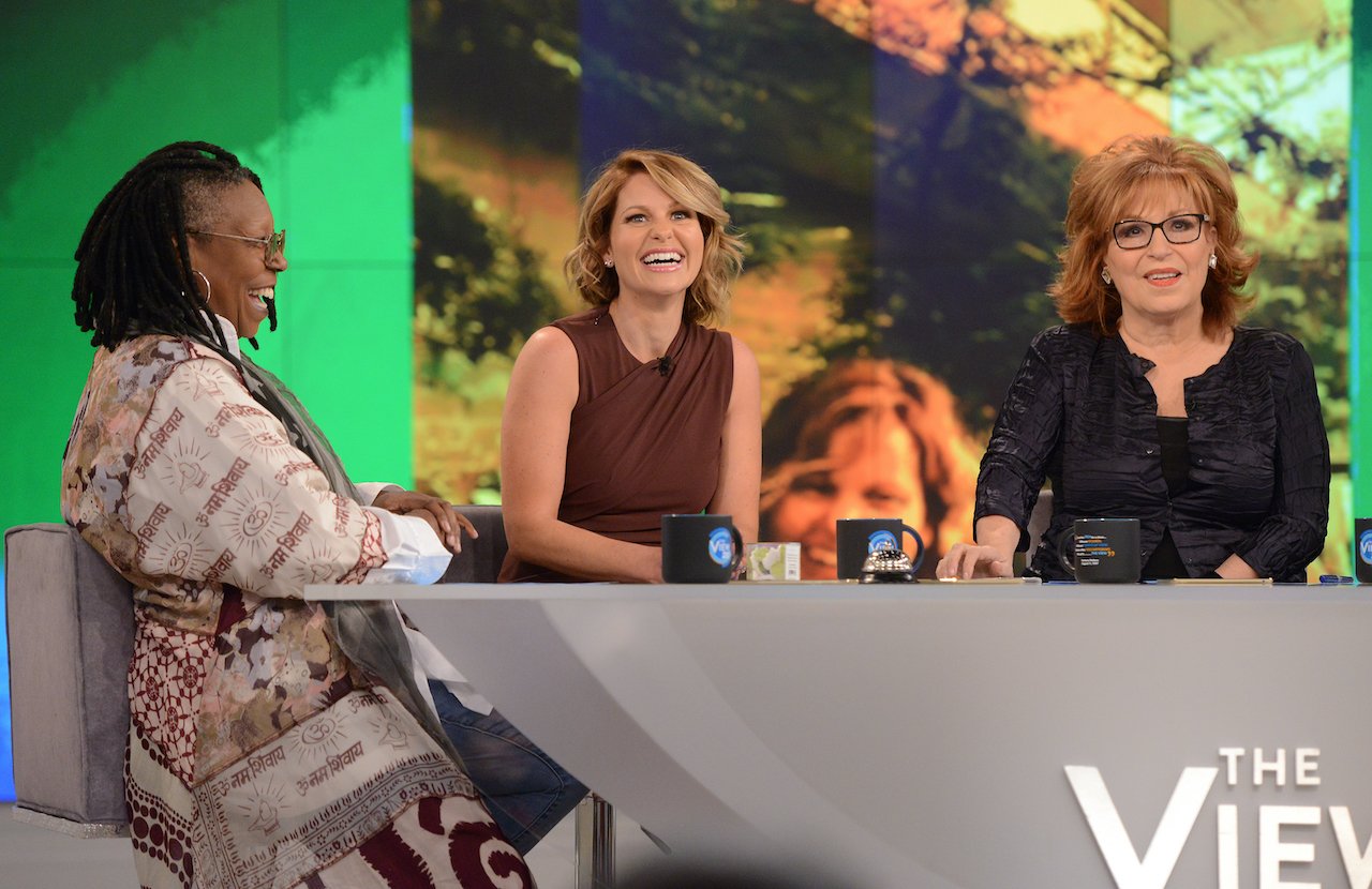 Whoopi Goldberg, Candace Cameron Bure, and Joy Behar at the table of 'The View' 