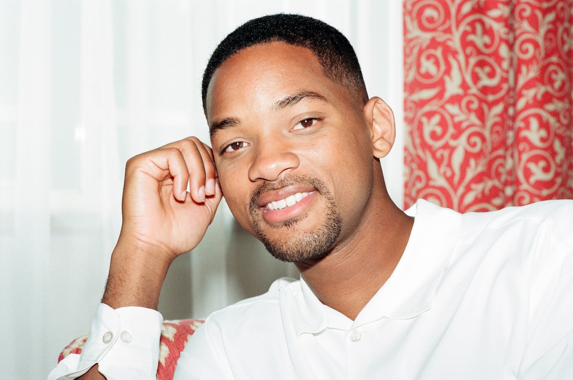 Will Smith with his fist on his cheek