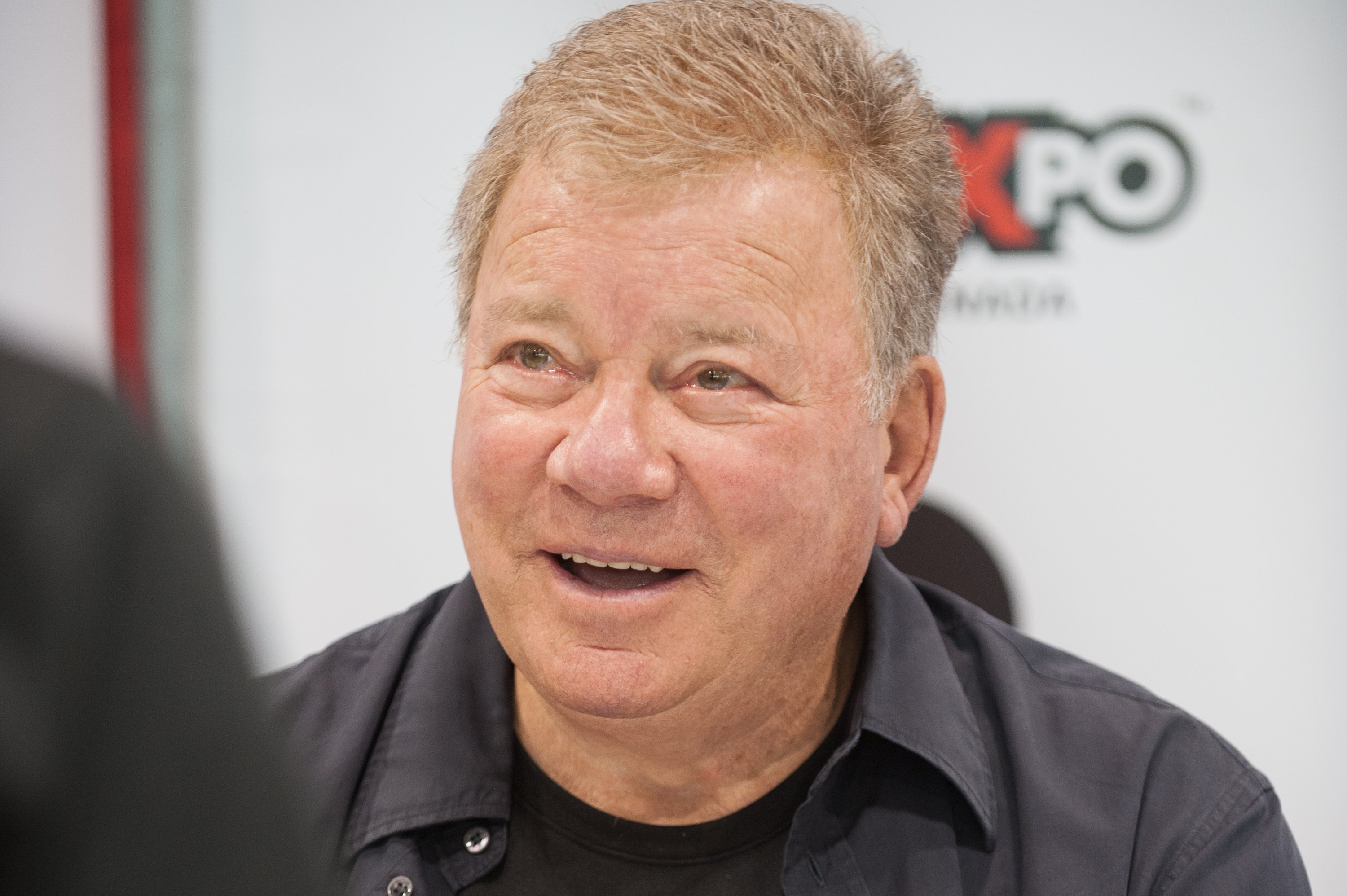 William Shatner talking to press in Canada. The shot is a close-up of his face.