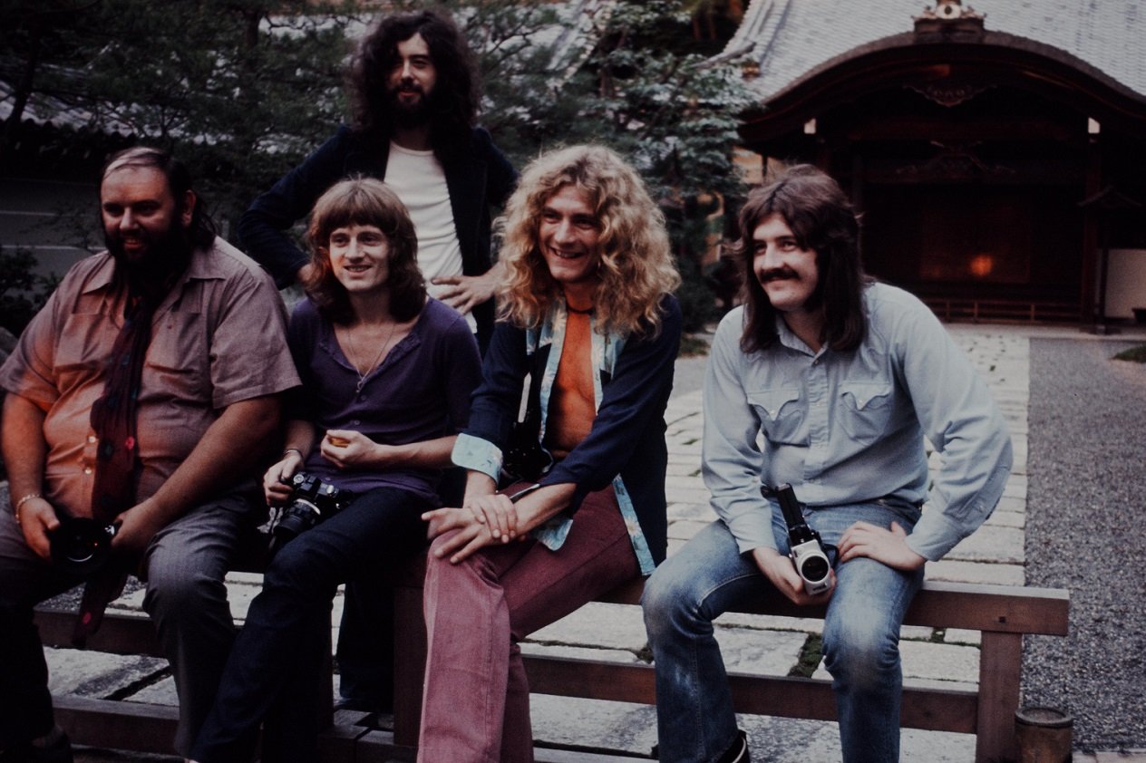 Led Zeppelin band members smiling for the camera during a 1971 tour of Japan