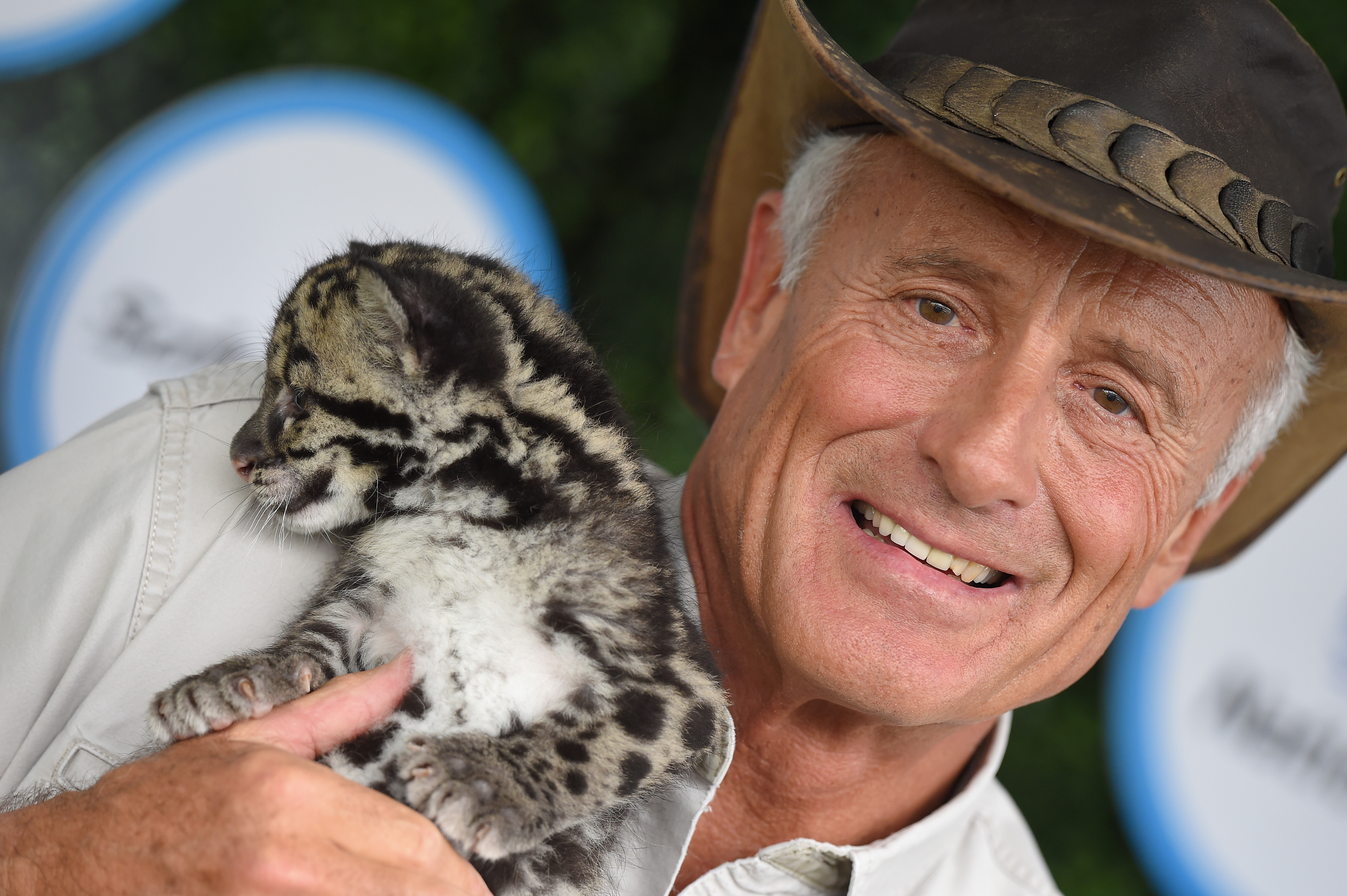 Zoologist Jack Hanna holding a wild baby cat at an event 