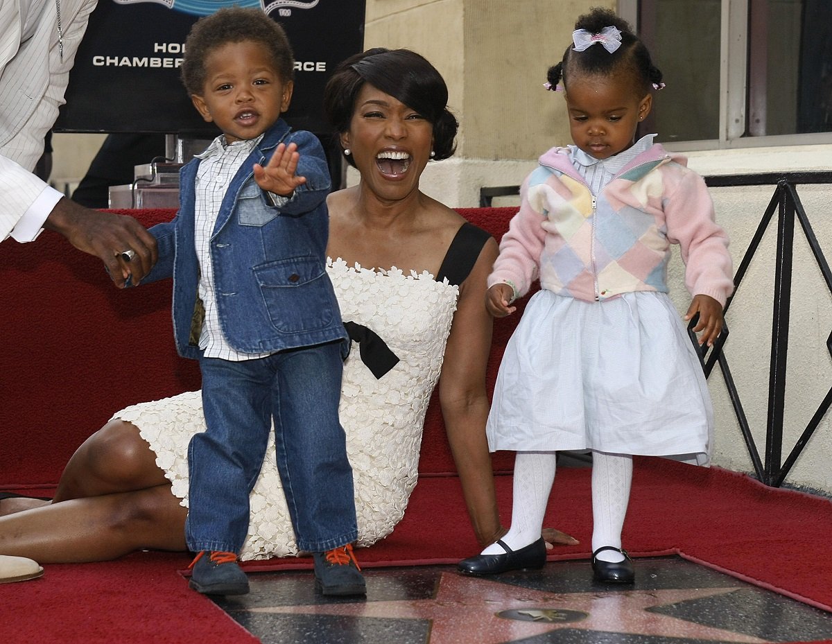Angela Bassett poses with her children Slater (L) and Bronwyn (R) beside her star on the Hollywood Walk of Fame on March 20, 2008.