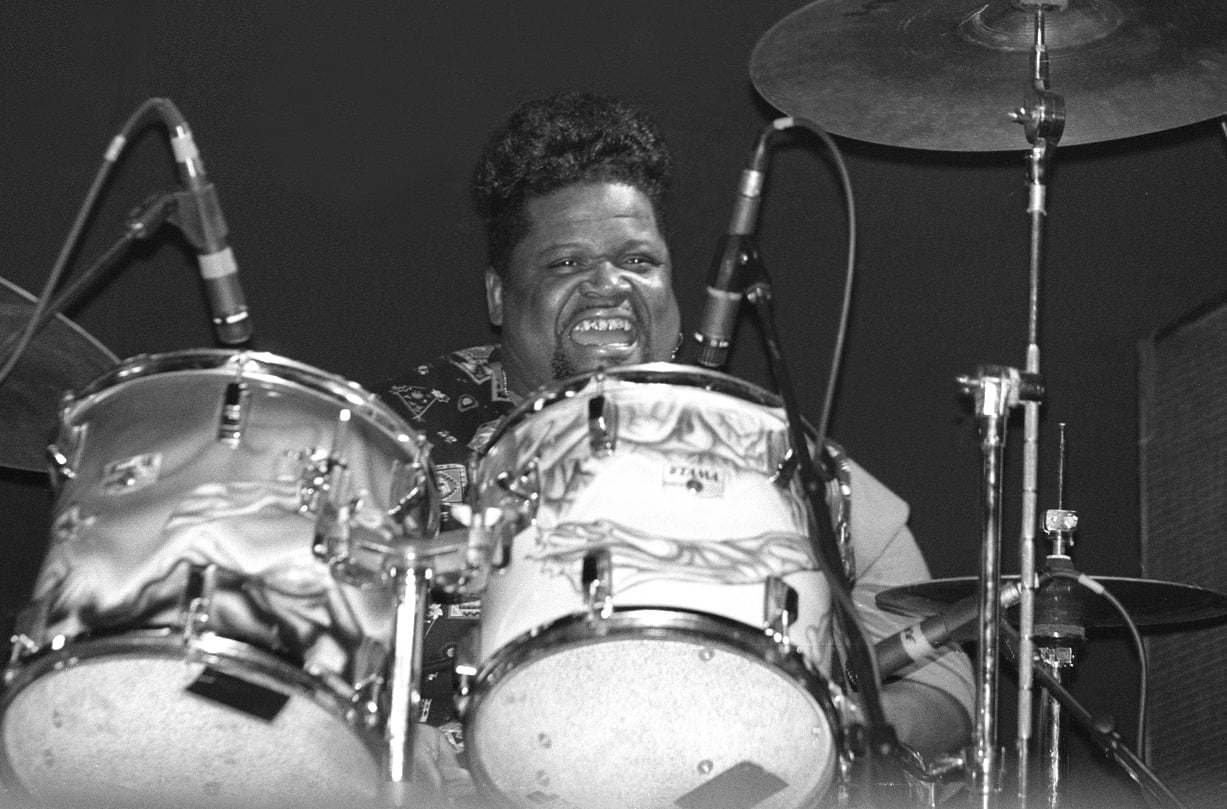 Buddy Miles smiles as he plays drums in 1999