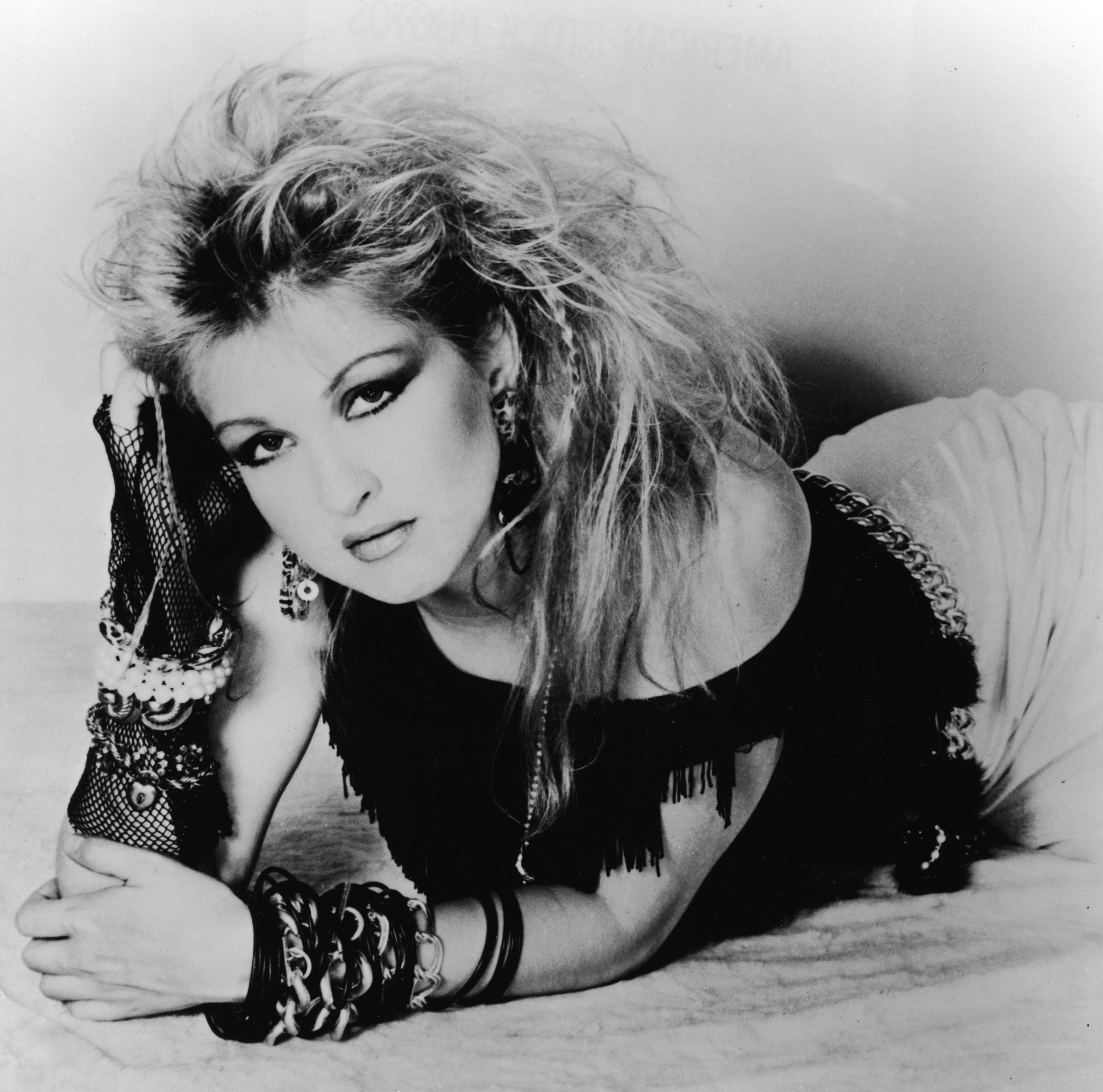 Cyndi Lauper lying on a floor