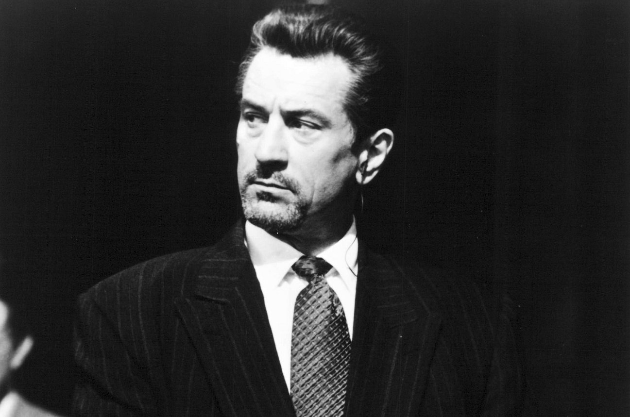 Robert De Niro wears a suit and looks off camera in a still from 'Heat'