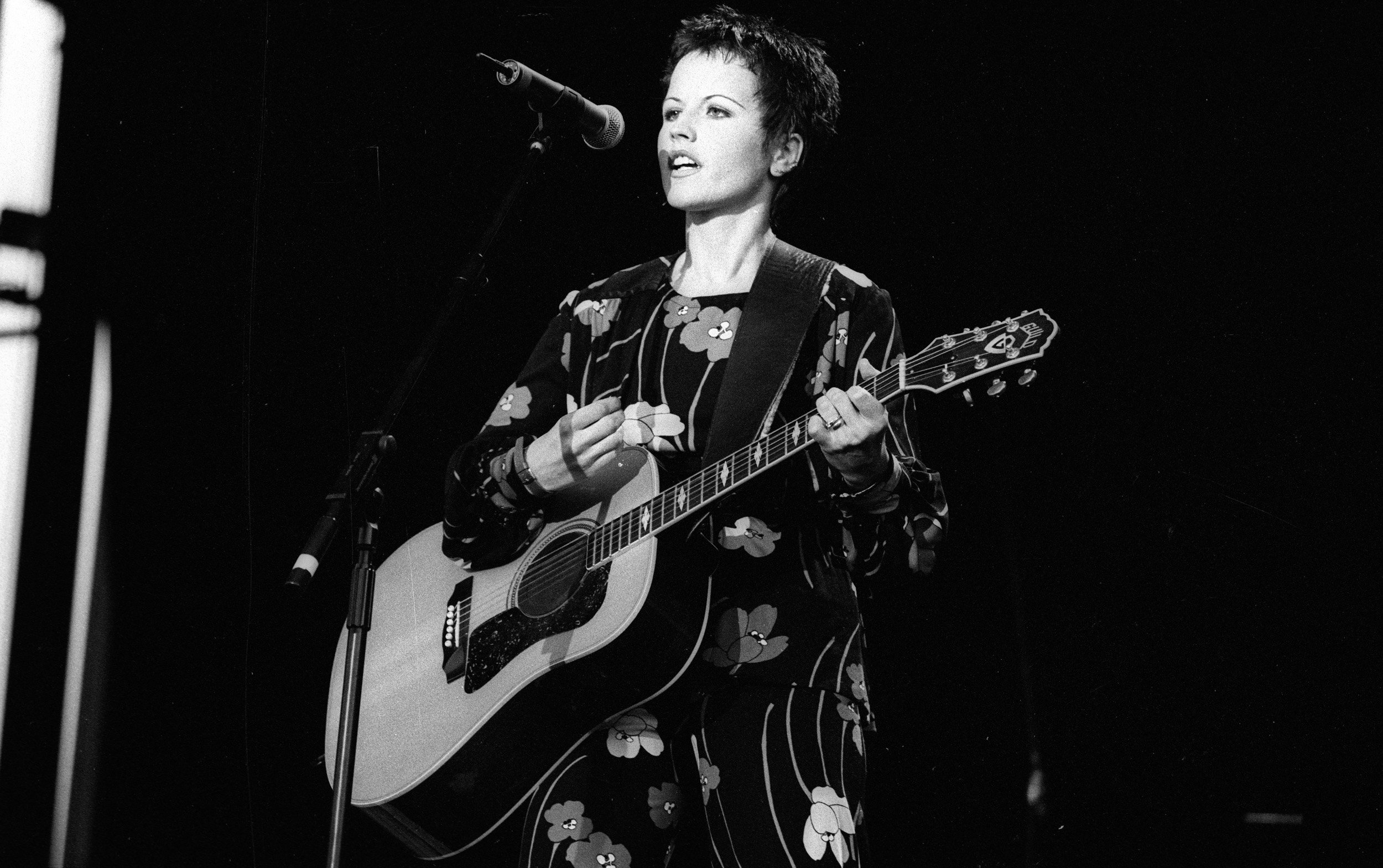Dolores O'Riordan of The Cranberries with a guitar