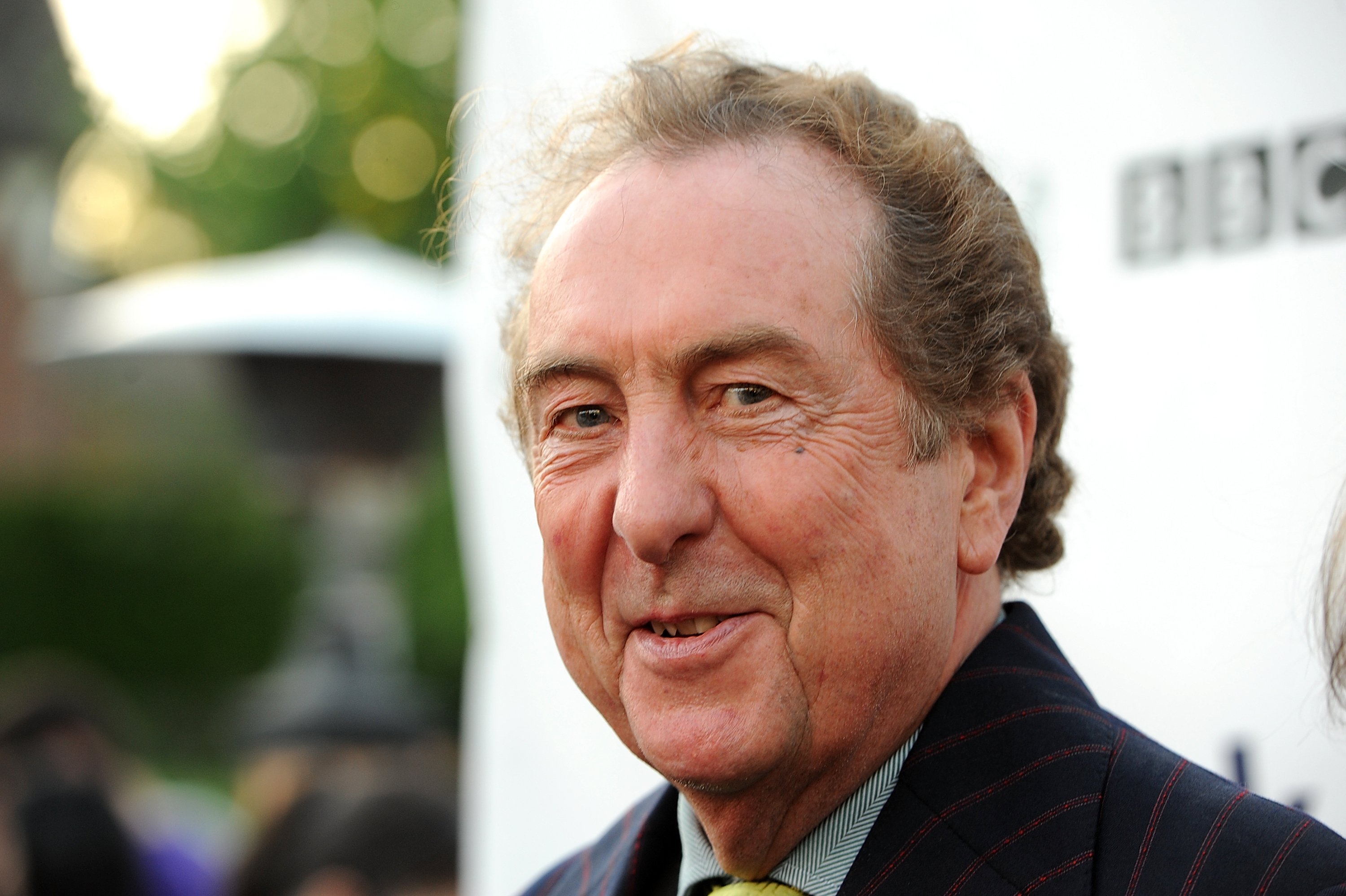 Eric Idle wearing a suit