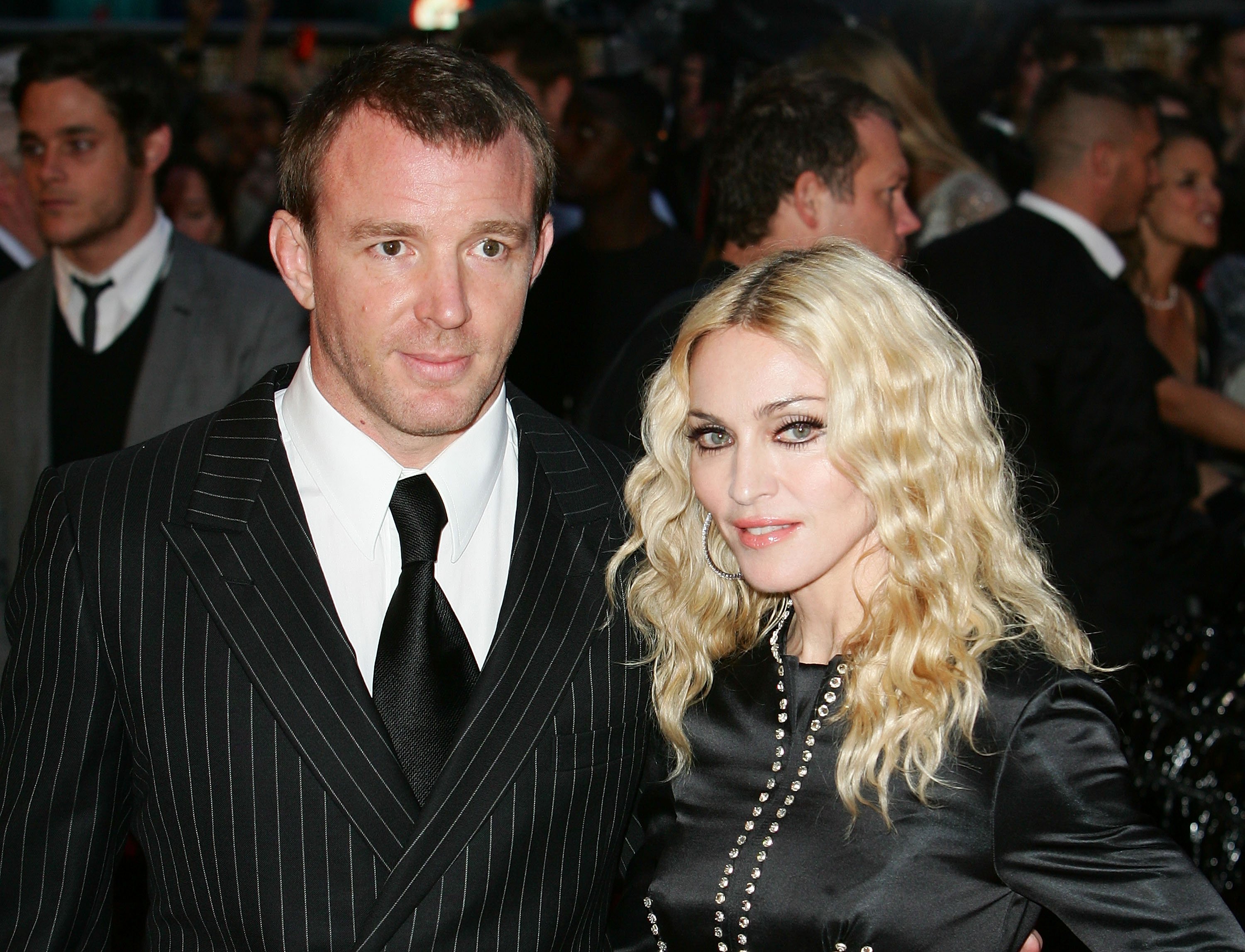 Madonna and Guy Ritchie in front of people