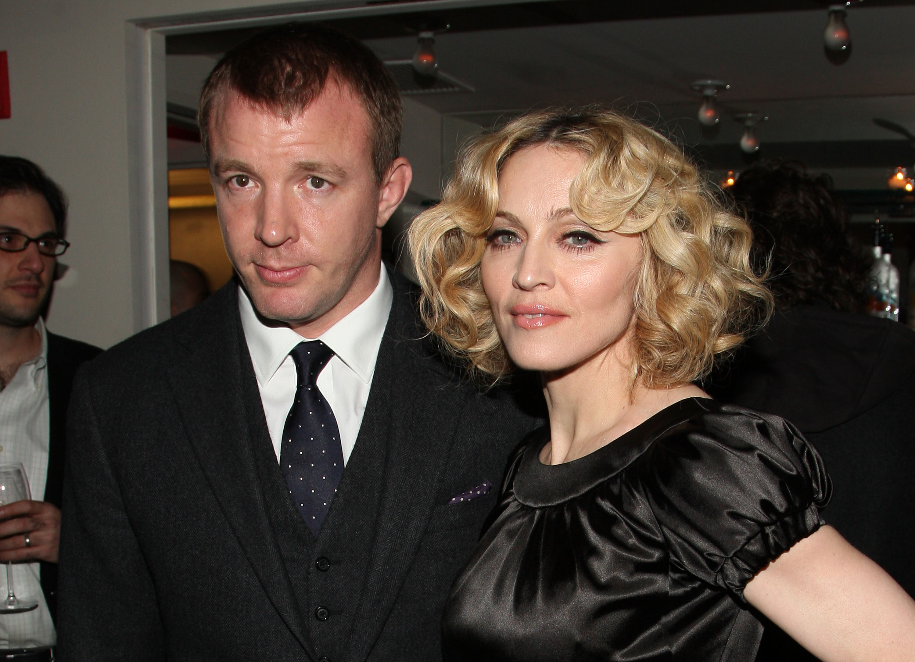 Madonna and Guy Ritchie in front of people