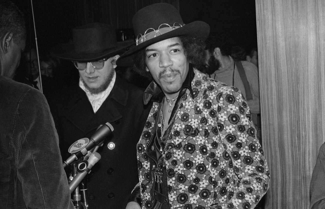 Jimi Hendrix smiles at something off-camera at a 1968 press event