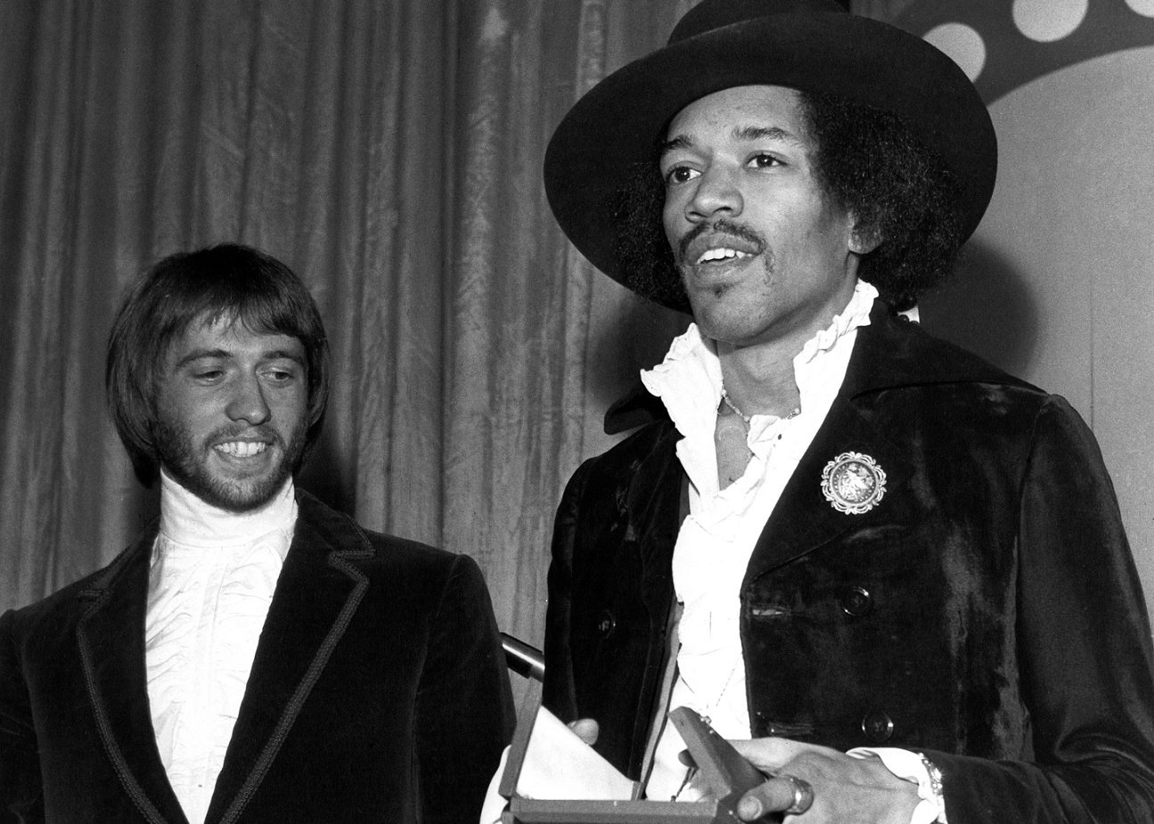 Jimi Hendrix smiles and holds an award