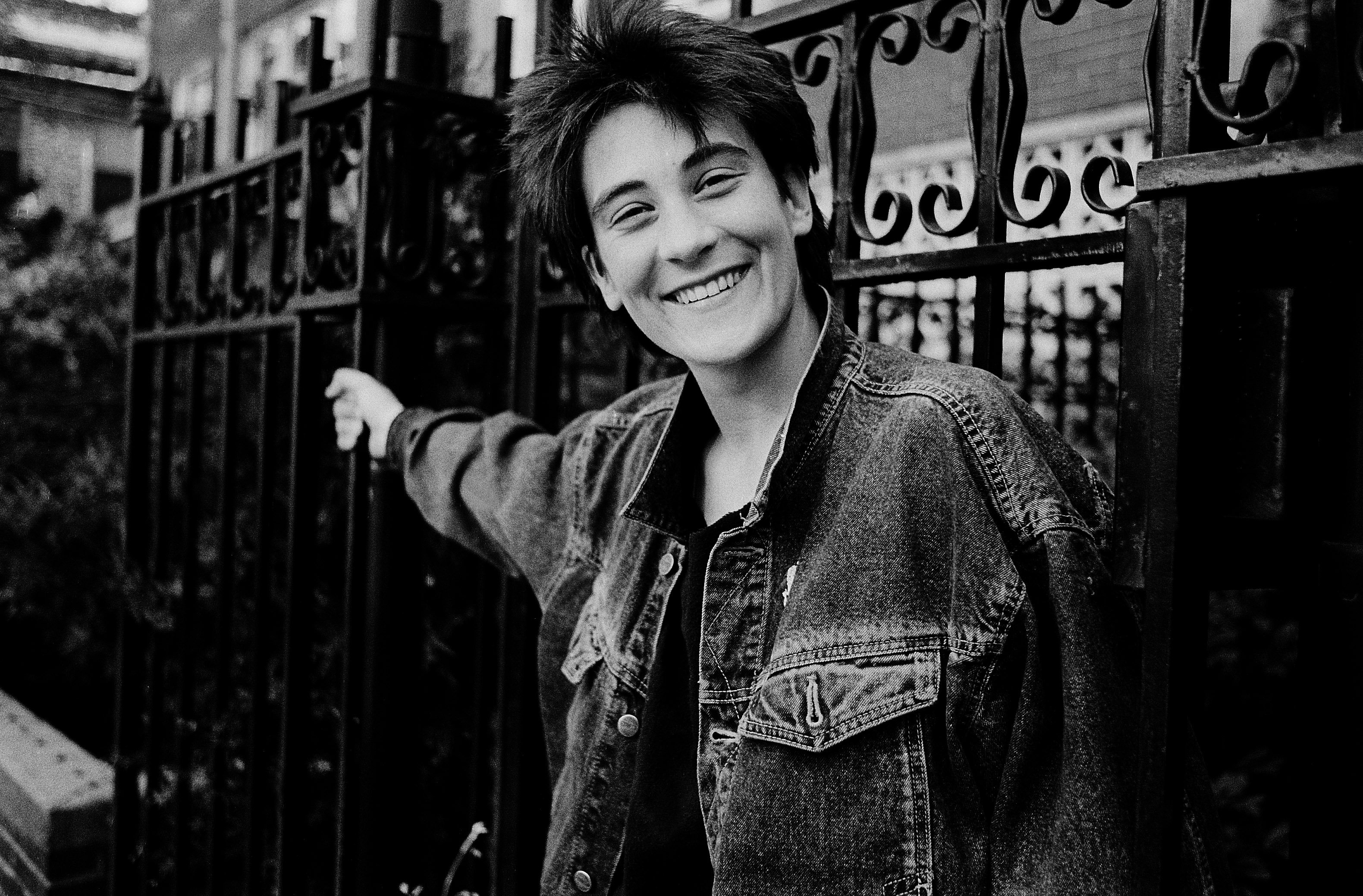 k.d. lang near a fence