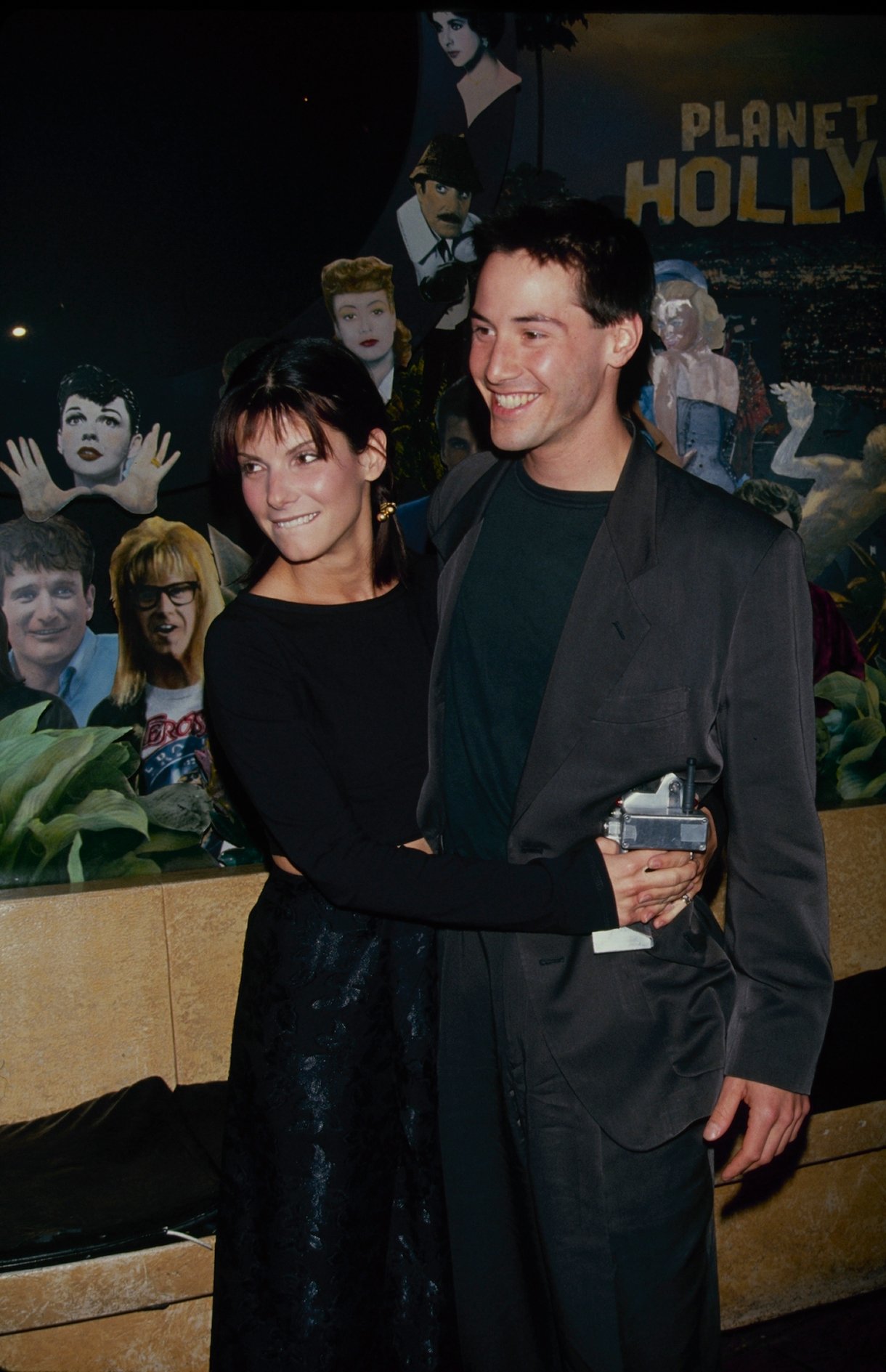 Circa 1994: Actors Sandra Bullock & Keanu Reeves at Planet Hollywood restaurant