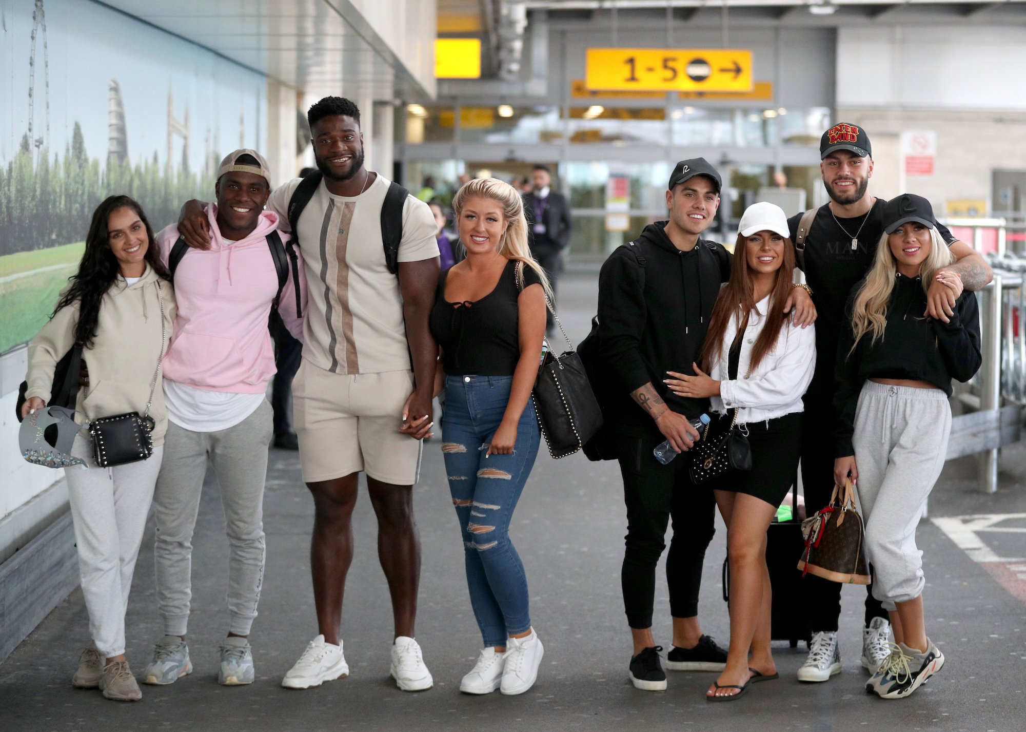 Siannise Fudge, Luke Trotman, Jess Gale, Ched Uzor, Luke Mabbott, Demi Jones, Finley Tapp, and Paige Turley at Heathrow Airport on Feb. 26, 2020 after filming season 6 of 'Love Island'