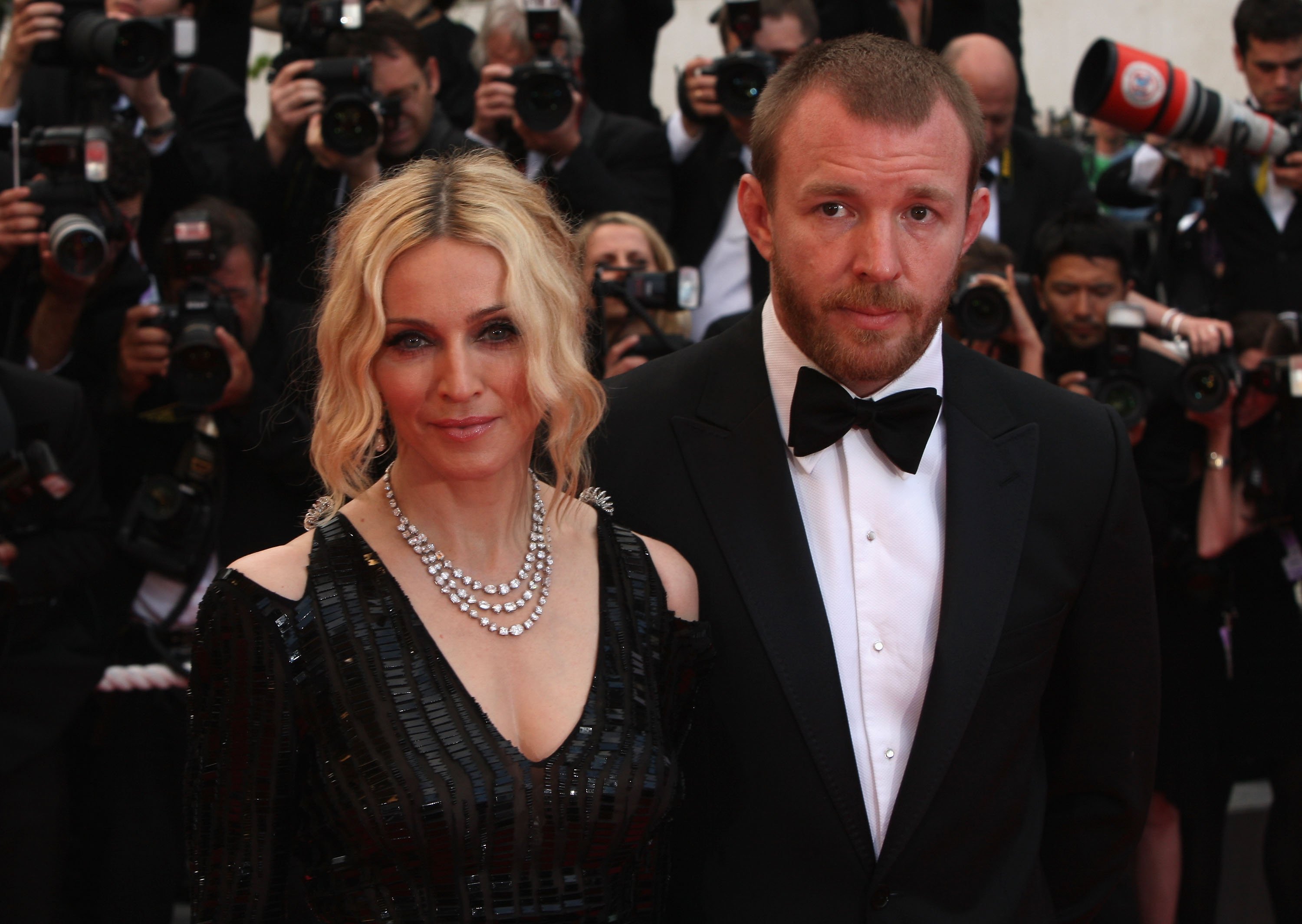 Madonna and Guy Ritchie in front of people