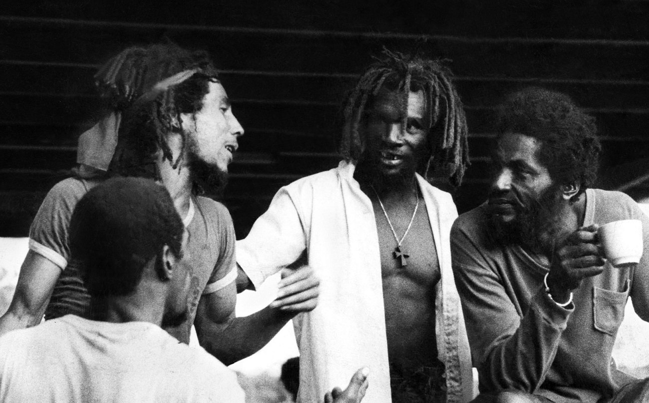 Bob Marley speaks with friends in Trench Town, 1974