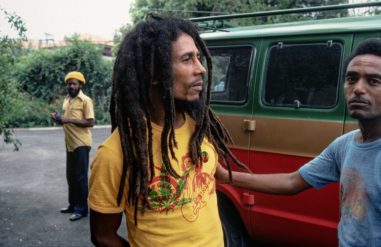 Bob Marley stands near a van outside his house in Jamaica