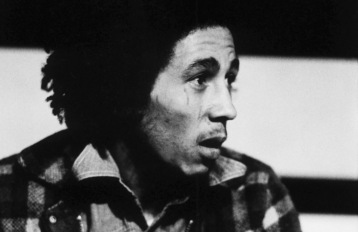 Bob Marley looks off-camera while speaking to an interviewer in 1973