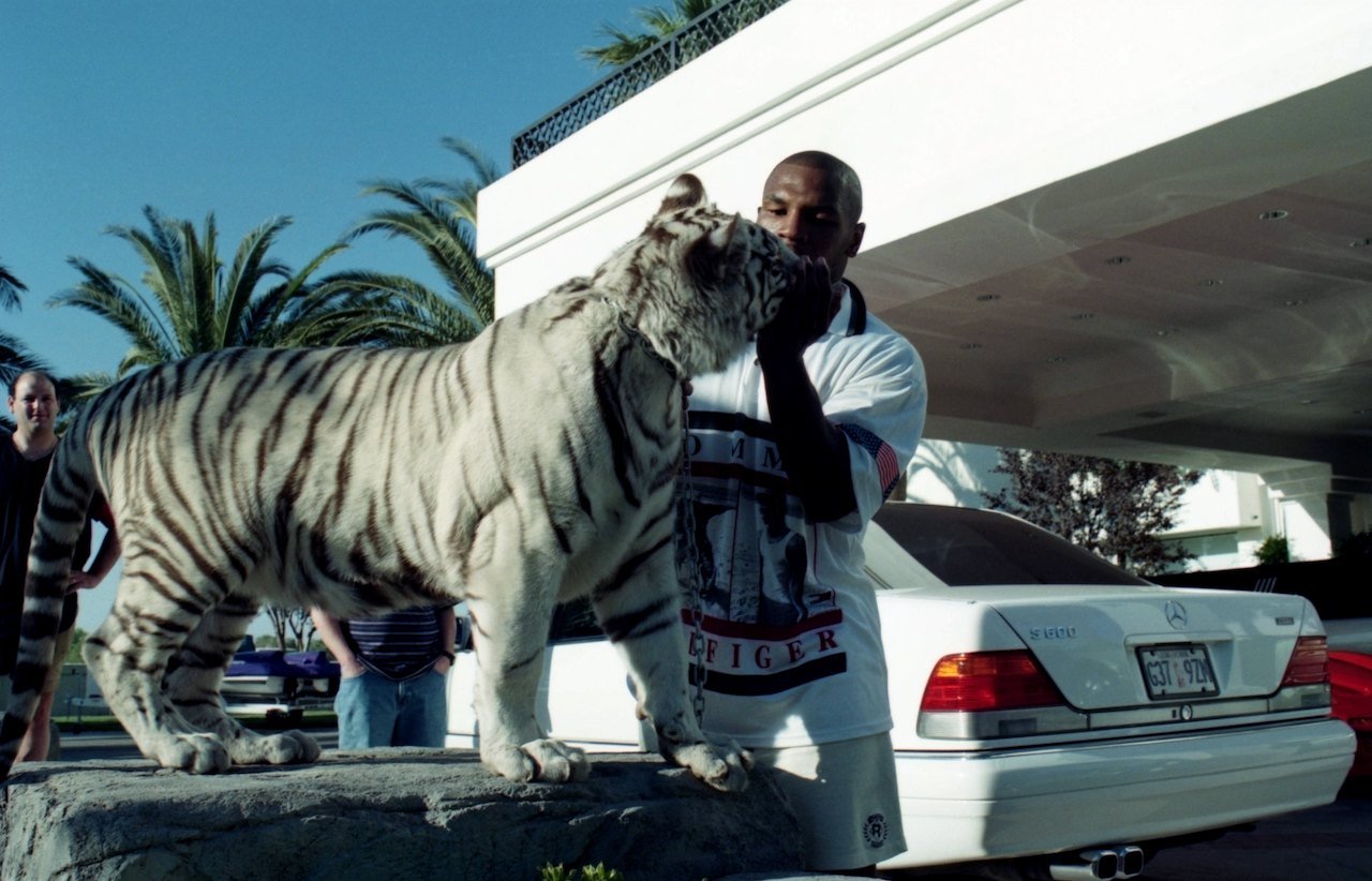 Mike Tyson poses with his white tiger during an interview at his home