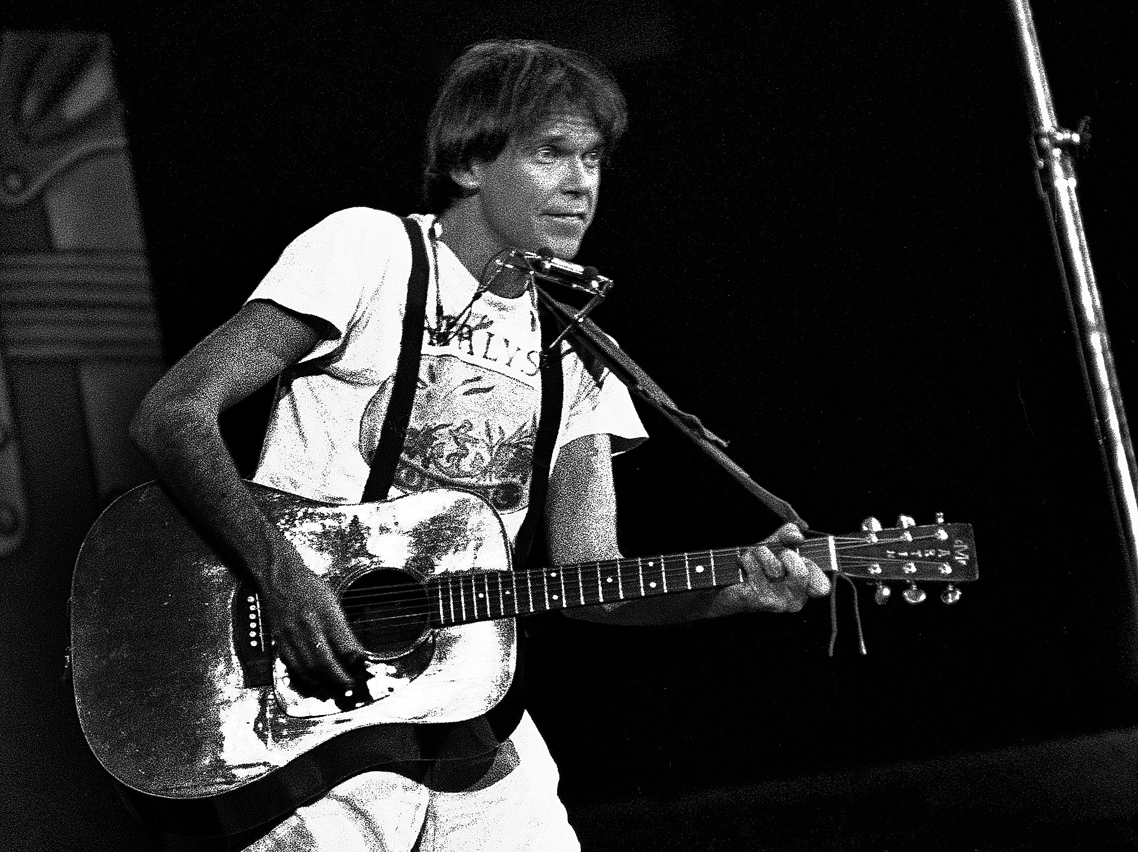 Neil Young holding a guitar