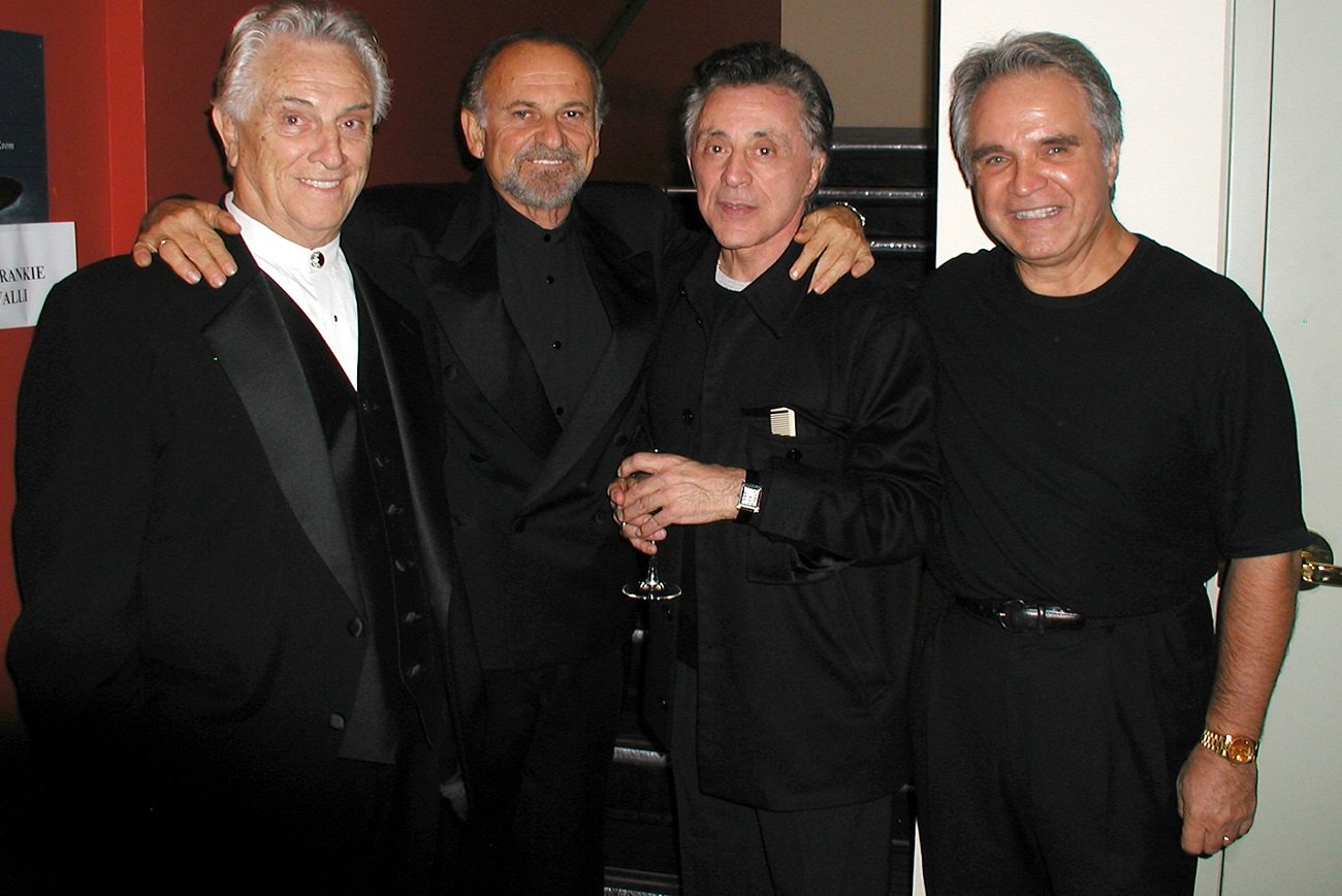 Tommy DeVito, Joe Pesci, Frankie Valli and Charlie Calello embrace one another and smile for the camera, circa 2006