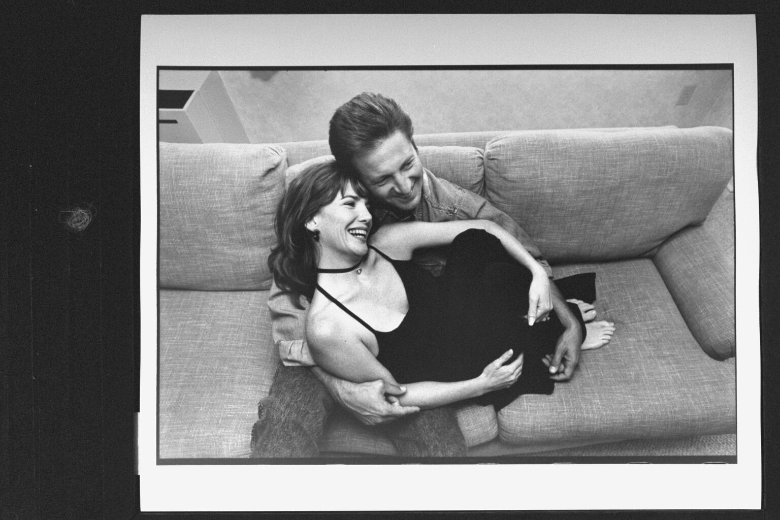 Melissa Gilbert curled up in the lap of her fiance Bruce Boxleitner on sofa in their hotel room.