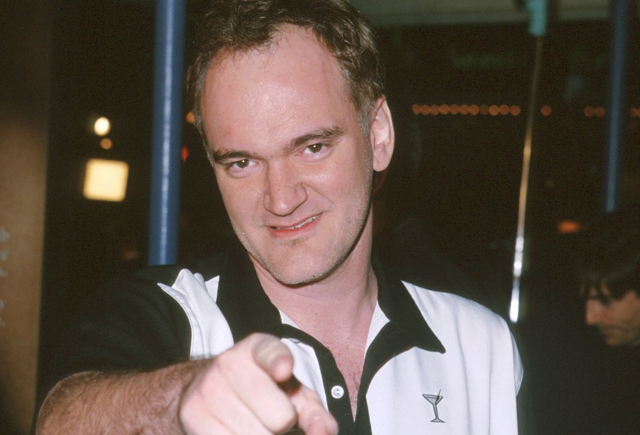 Quentin Tarantino points at the camera at a film premiere