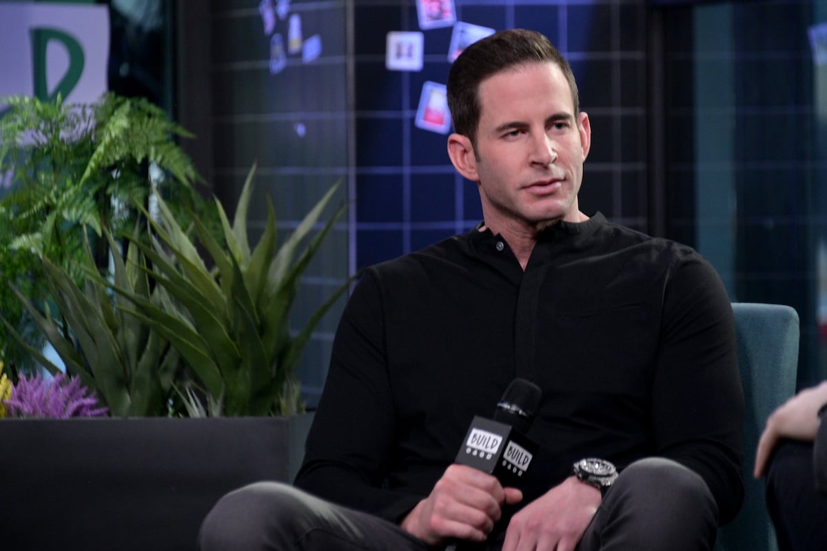 Tarek El Moussa holding a microphone 