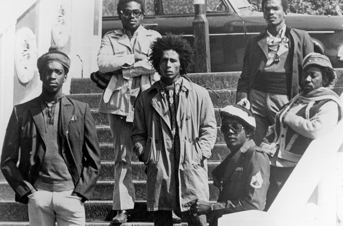 The Wailers pose for a portrait in London in 1973. Bob Marley stands in the center of the group.